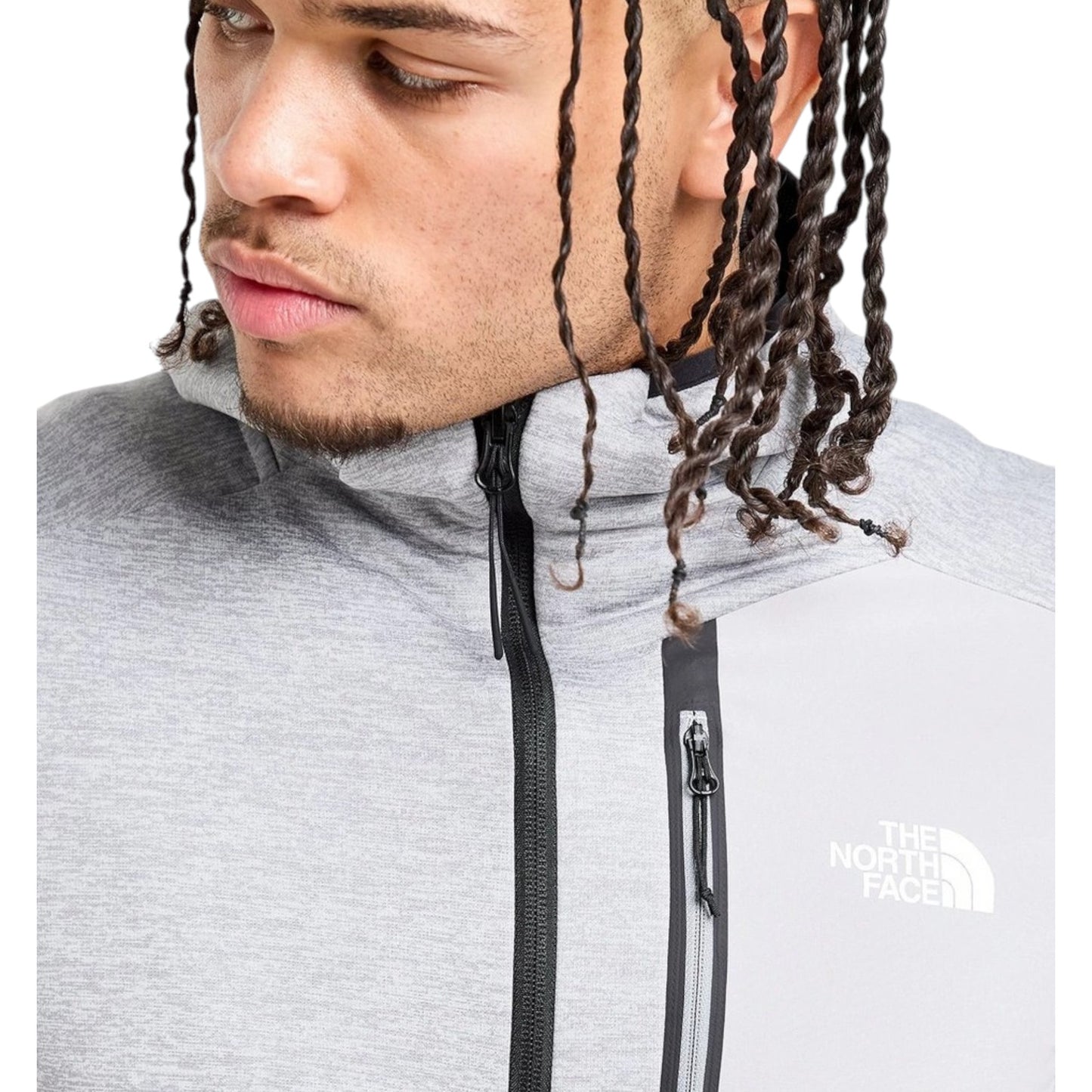 Person wearing a gray The North Face jacket with a close-up of the brand logo.