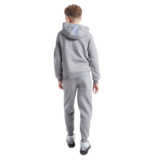 Person wearing a gray tracksuit on a white background
