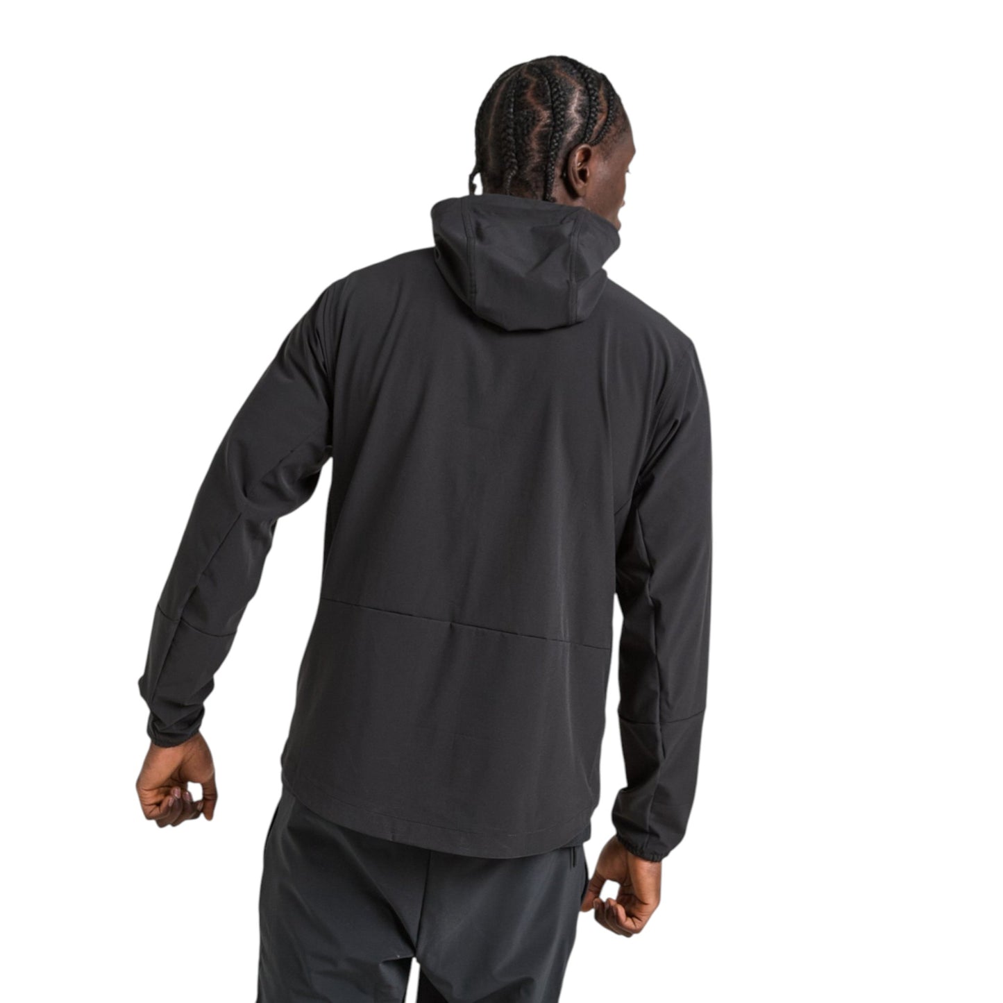 Person wearing a black jacket and pants on a white background