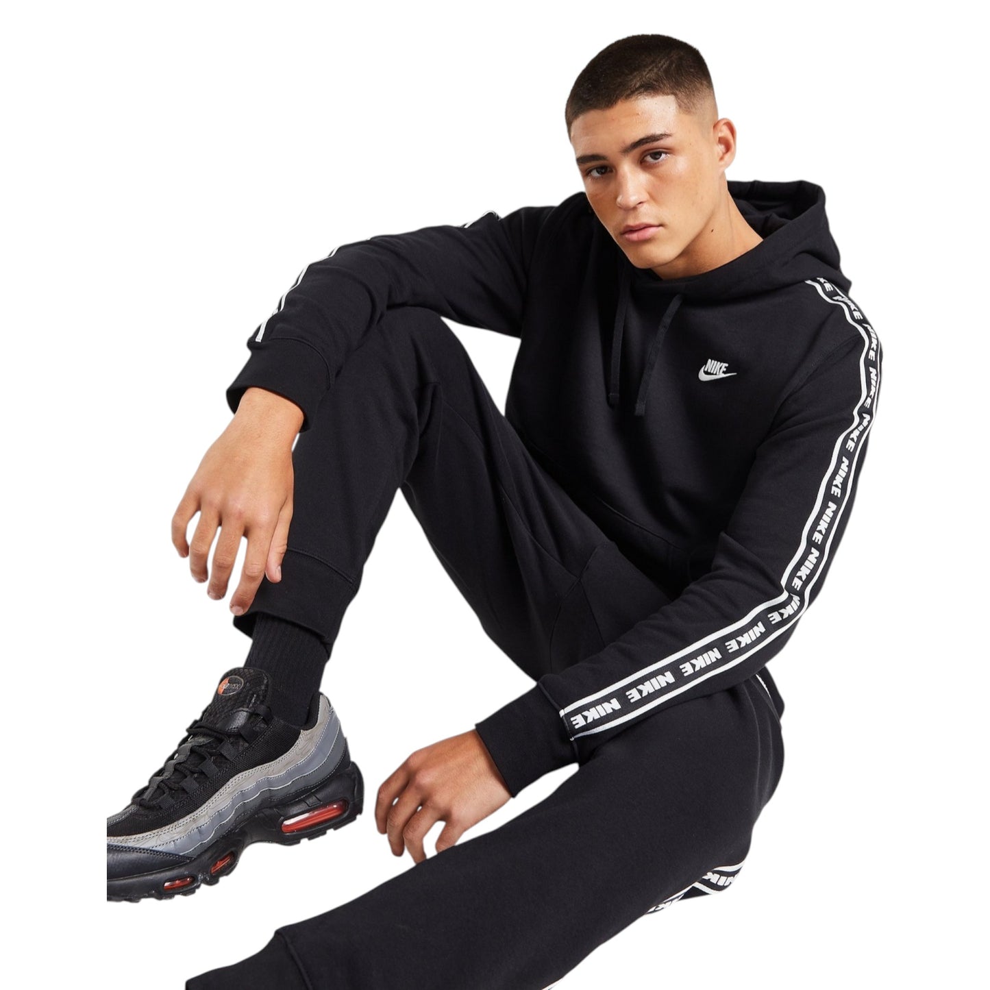 Person wearing a black Nike tracksuit with white stripes on a white background
