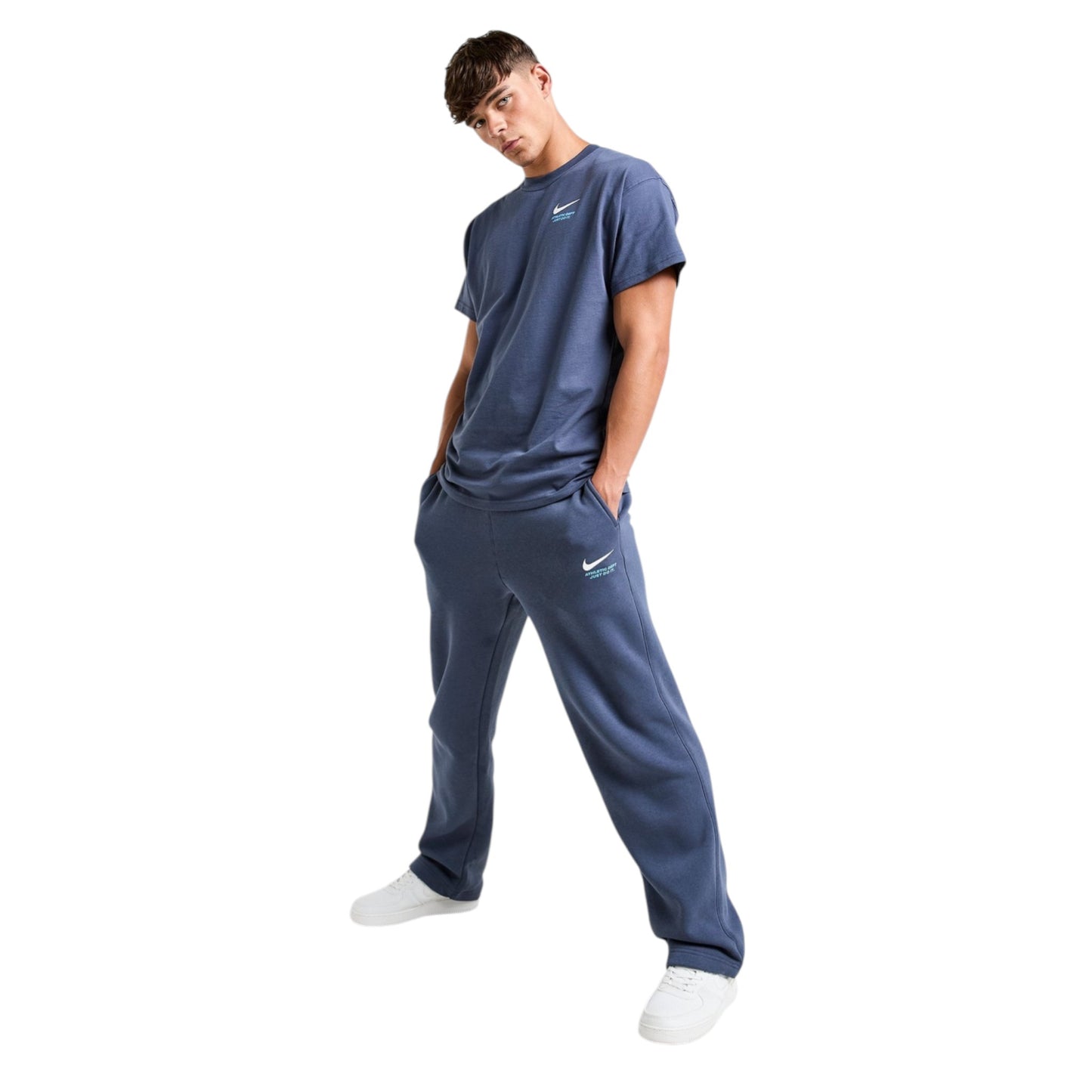 Person wearing a navy blue Nike tracksuit on a white background