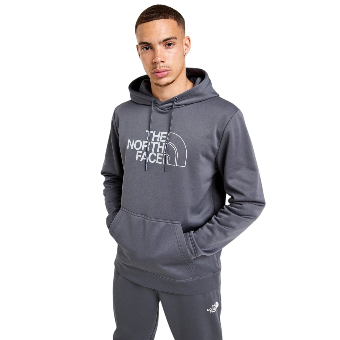 Person wearing a gray hoodie with 'The North Face' logo on a white background