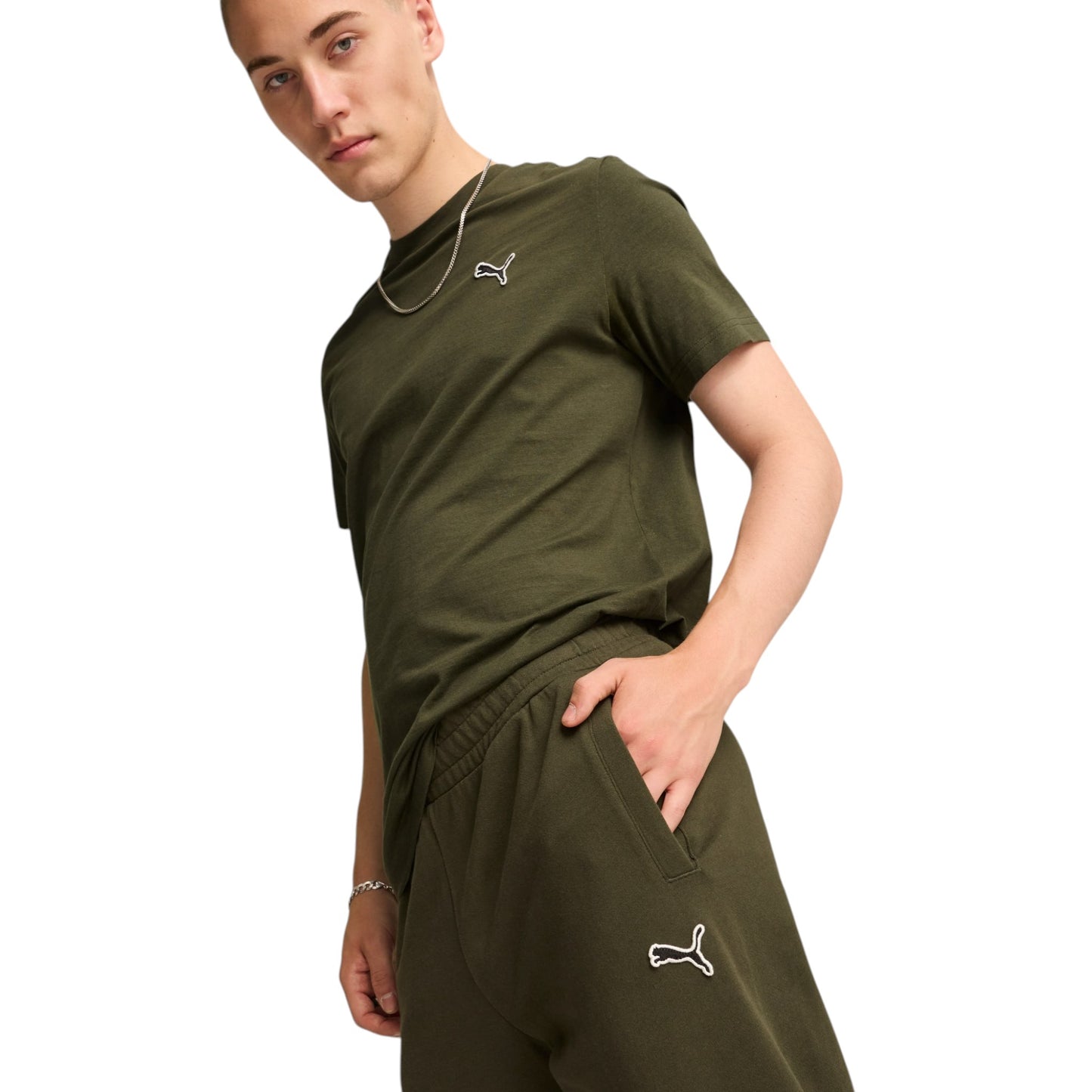 Person wearing an olive green outfit with a brand logo on a white background