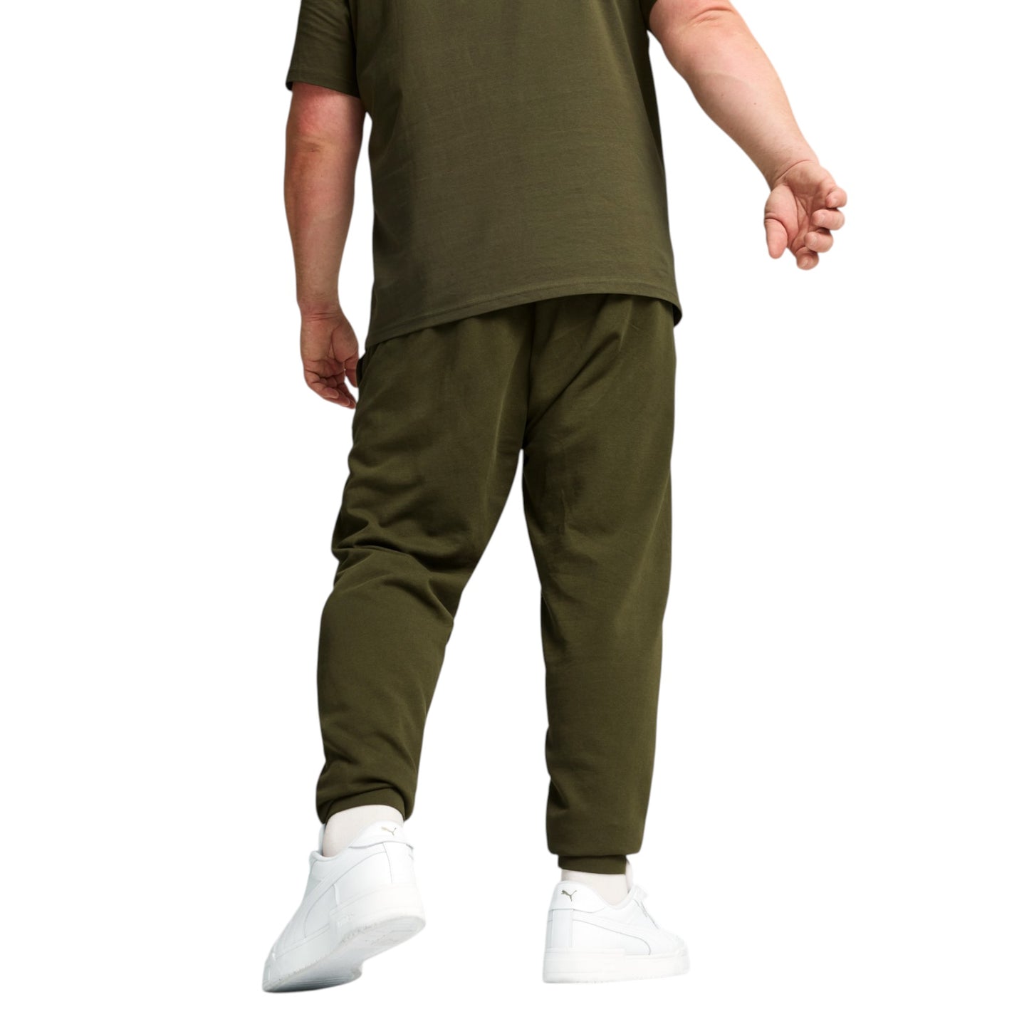 Person wearing an olive green outfit with white sneakers on a white background