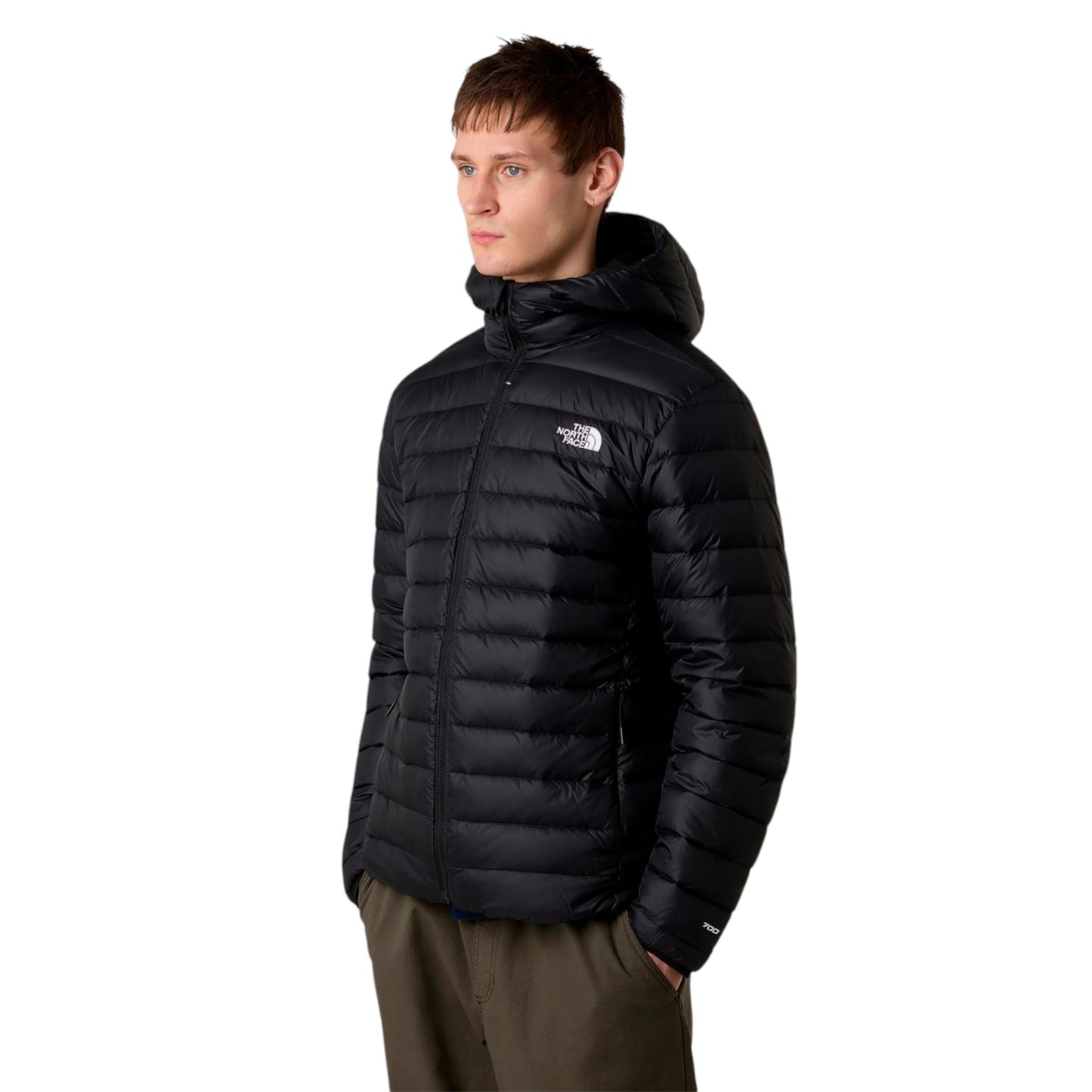 Man wearing a black puffer jacket with a brand logo on a white background
