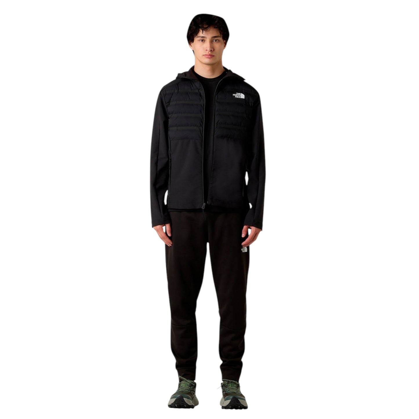 Person wearing a black jacket and pants with a logo on a white background