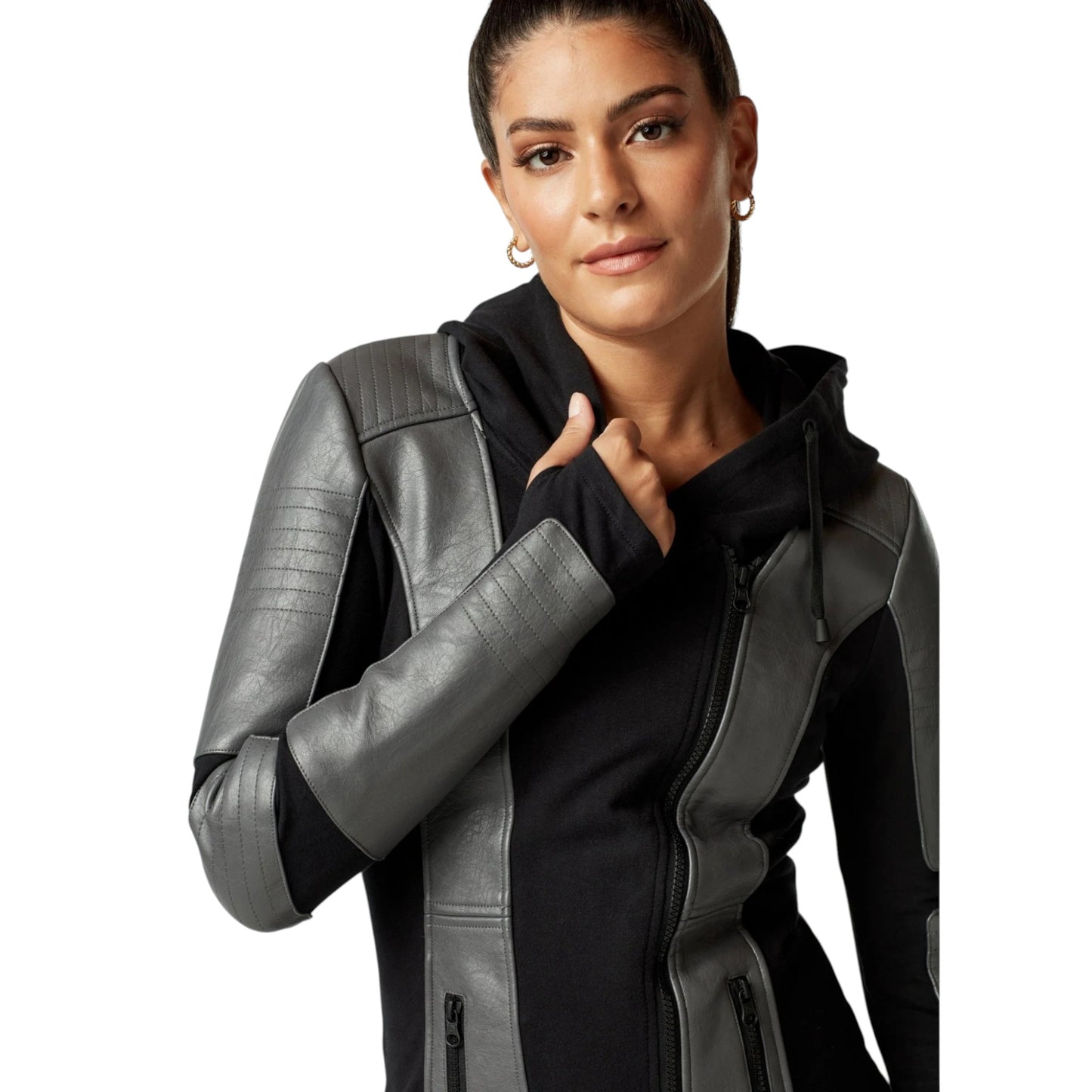Woman wearing a black and gray jacket with leather sleeves on a white background