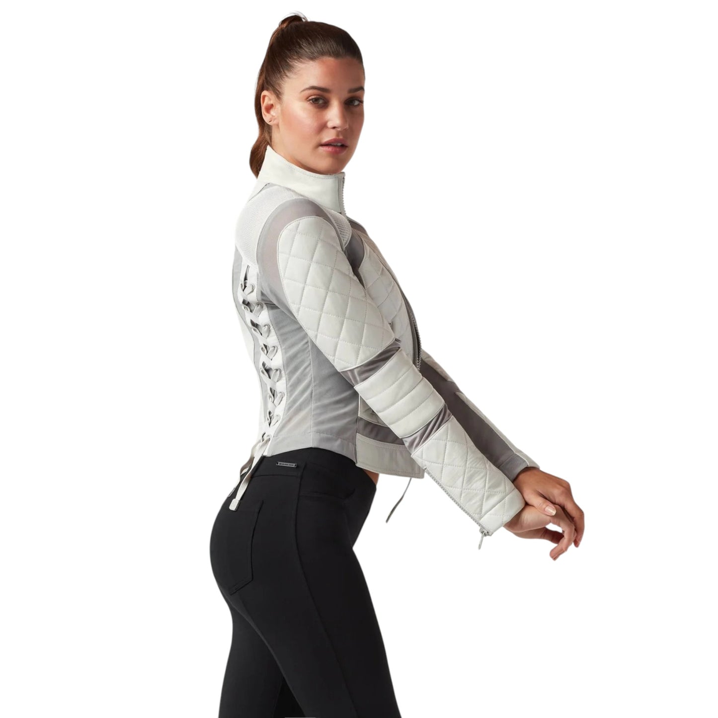 Woman wearing a white quilted equestrian jacket on a white background