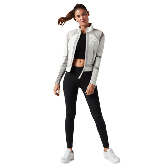 Woman wearing a gray and black athletic outfit on a white background
