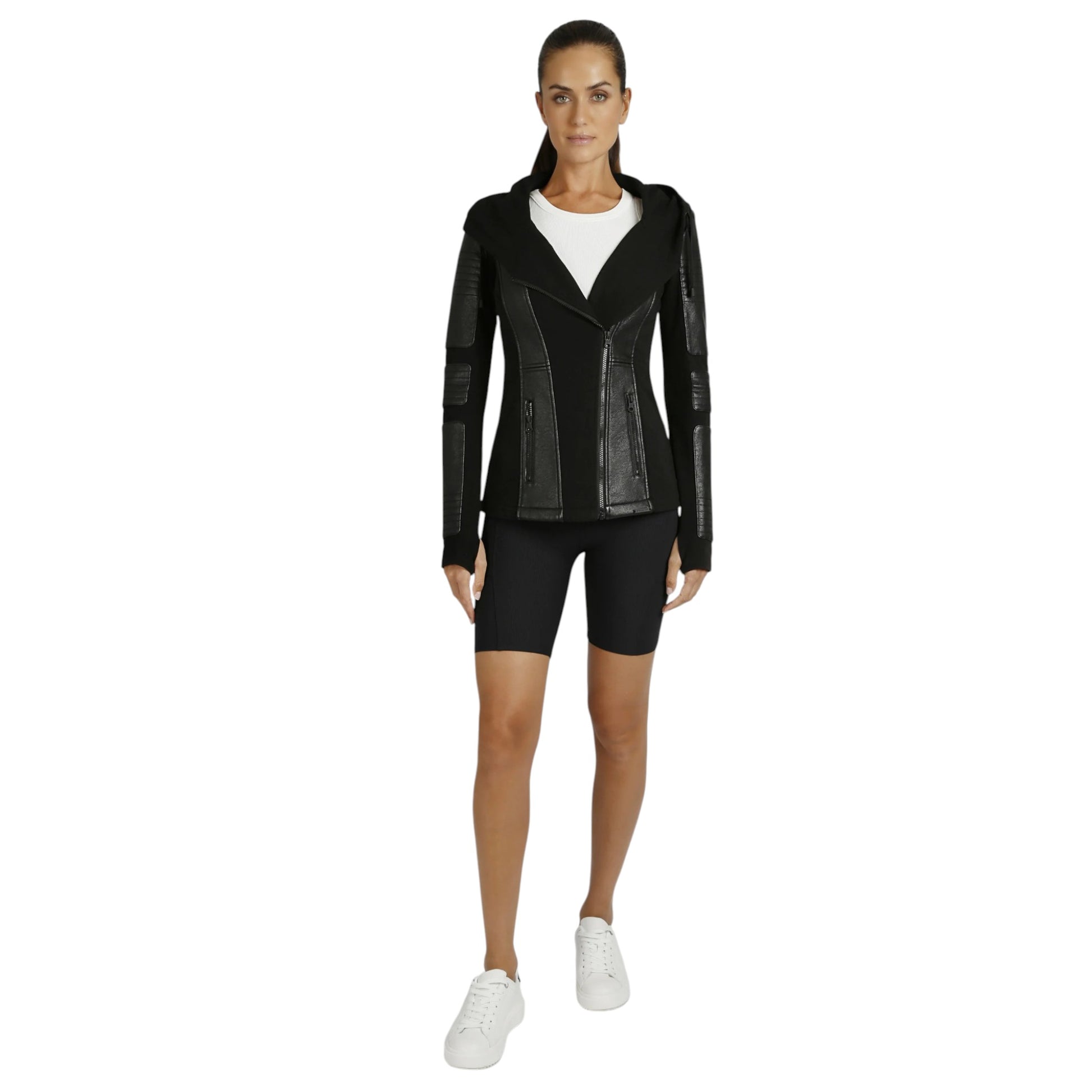 Woman wearing a black leather jacket and black shorts on a white background