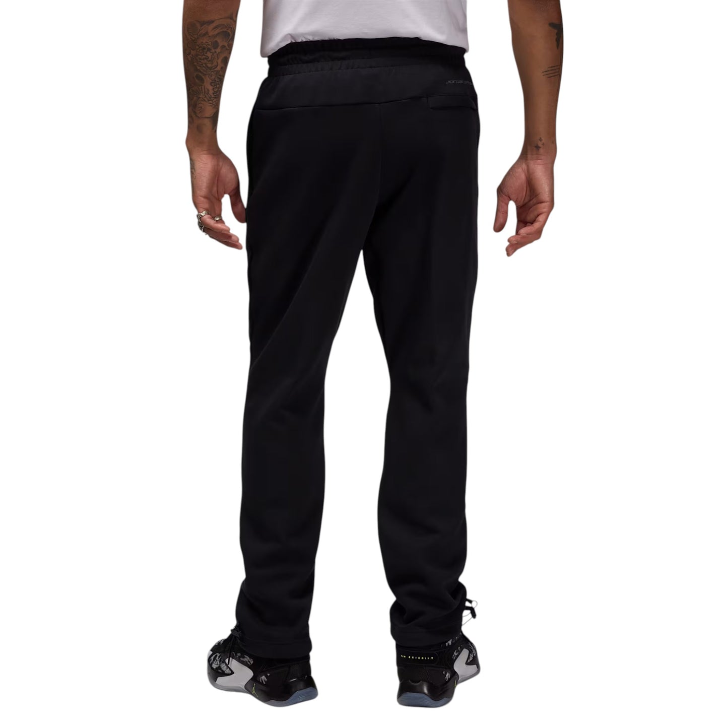 Person wearing black pants on a white background