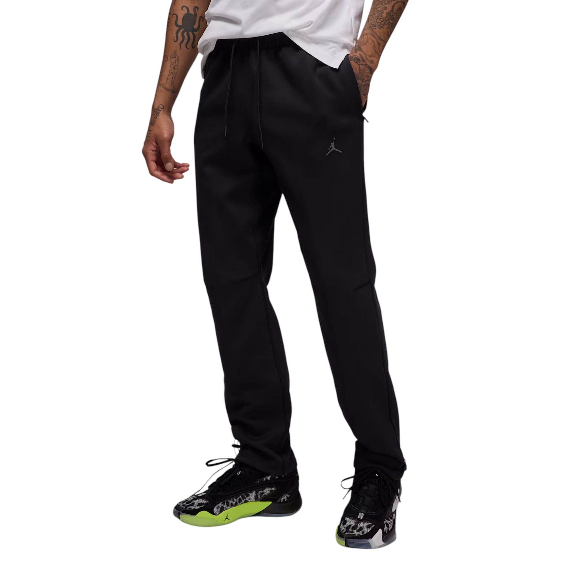Person wearing black Jordan pants on a white background