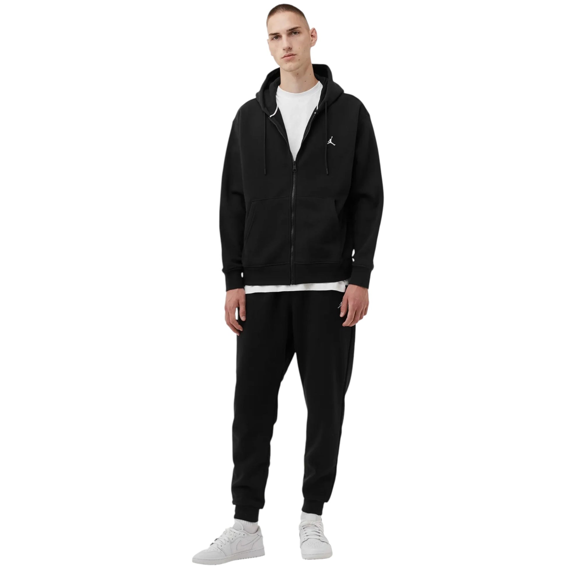 Man wearing a black tracksuit with a logo on a white background