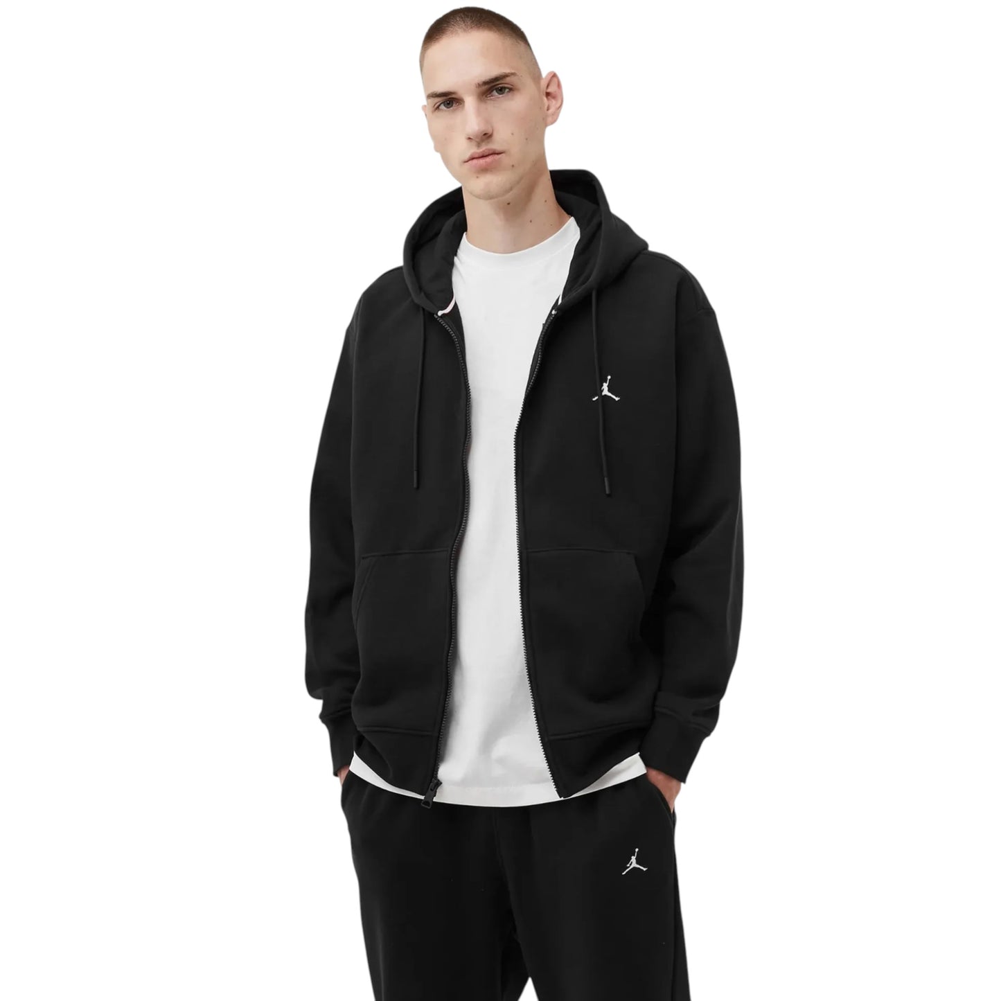 Man wearing a black hoodie and pants with a logo on a white background