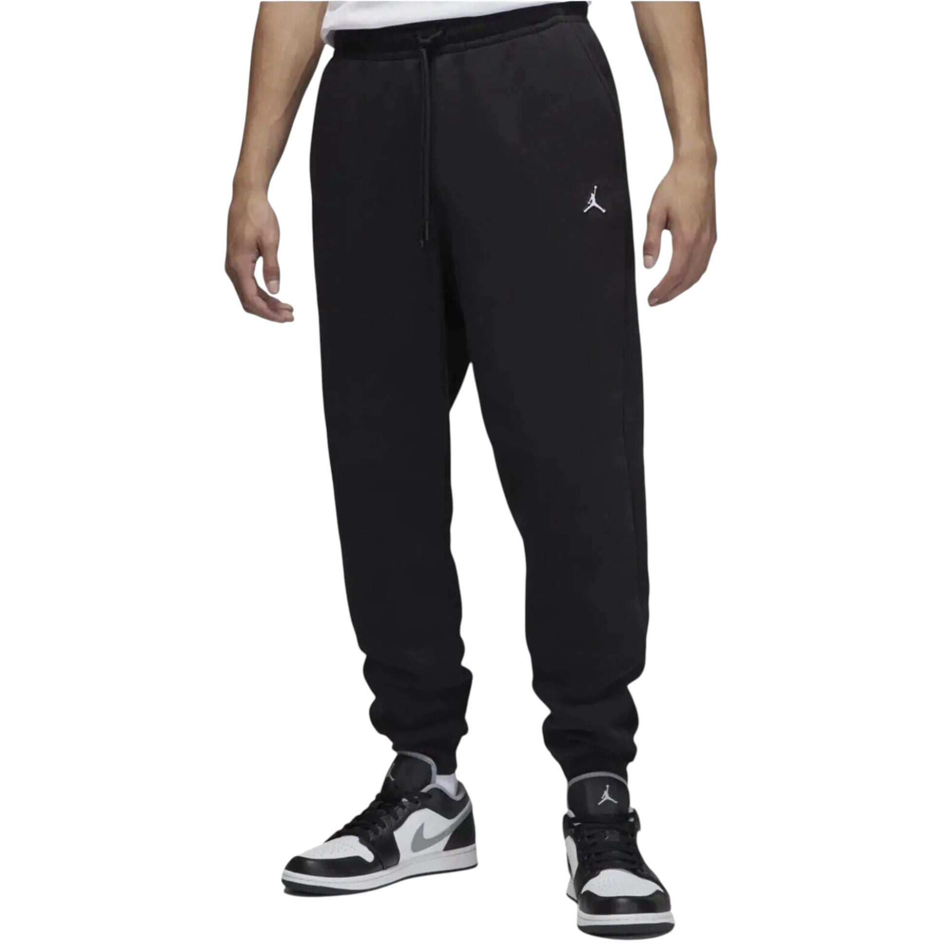 Black Jordan sweatpants worn by a person on a white background