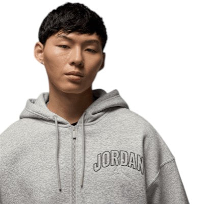 Person wearing a gray hoodie with 'Jordan' branding on a white background
