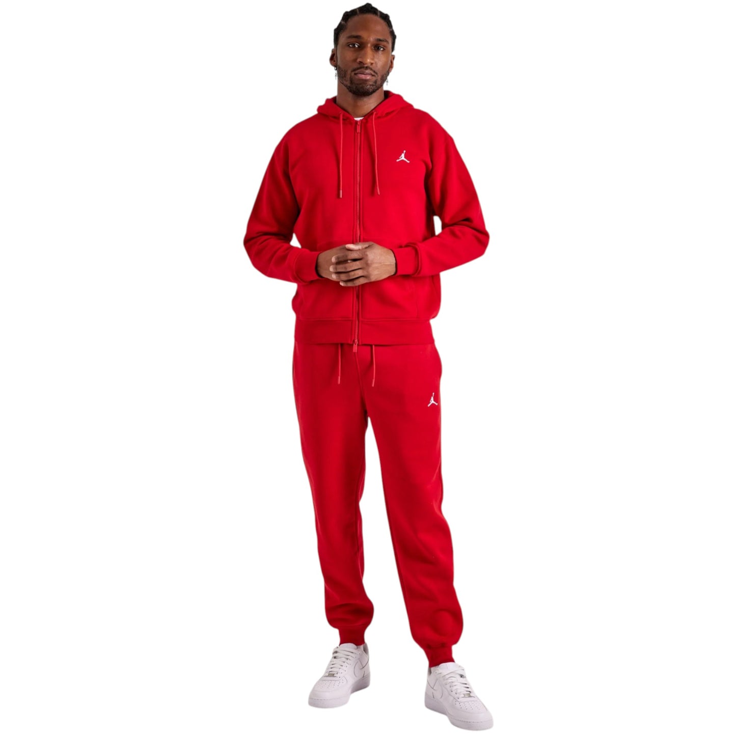 Person wearing a red Jordan tracksuit on a white background