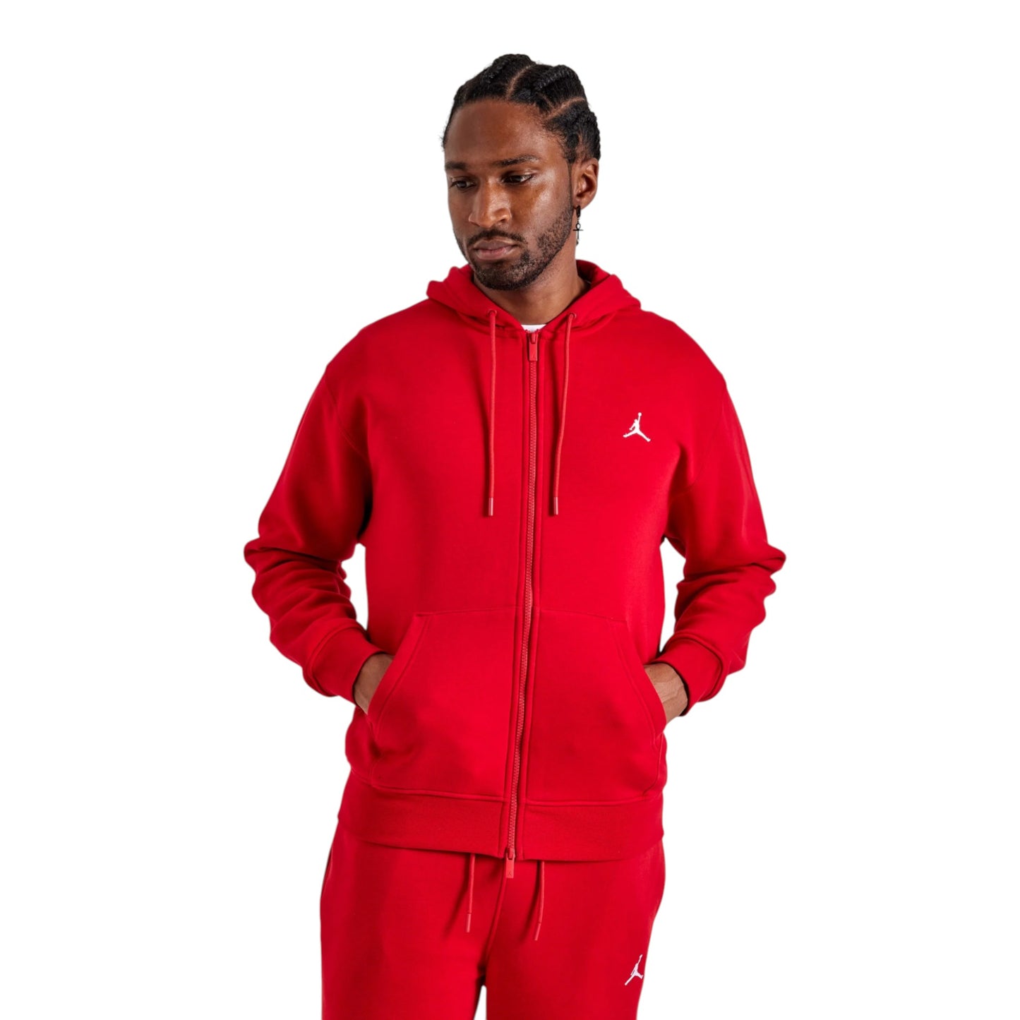 Person wearing a red Jordan tracksuit on a white background