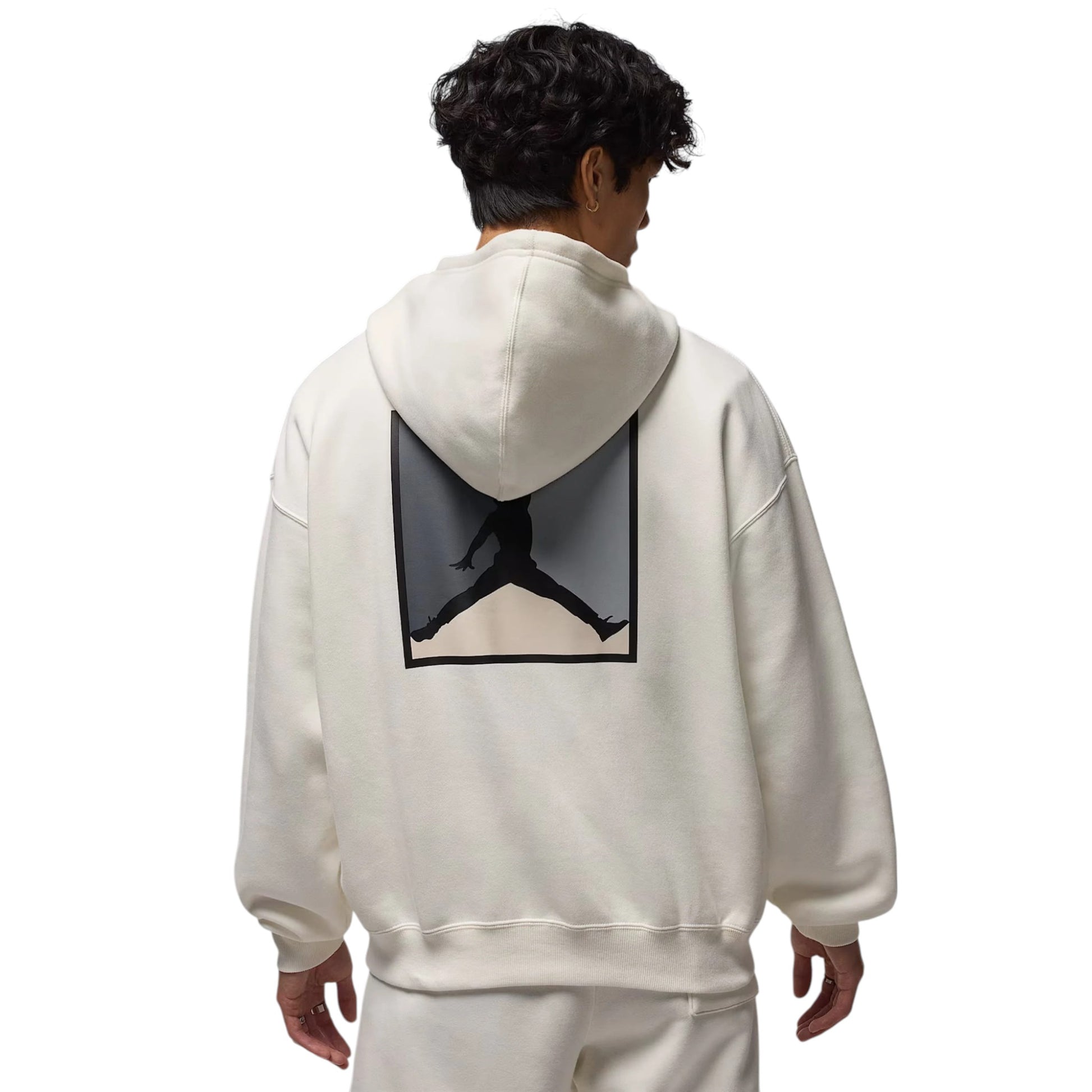 Person wearing a white hoodie with a logo on the back against a white background