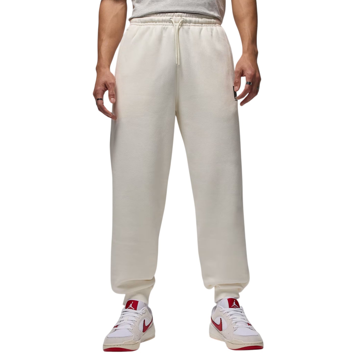 Beige sweatpants worn by a person on a white background