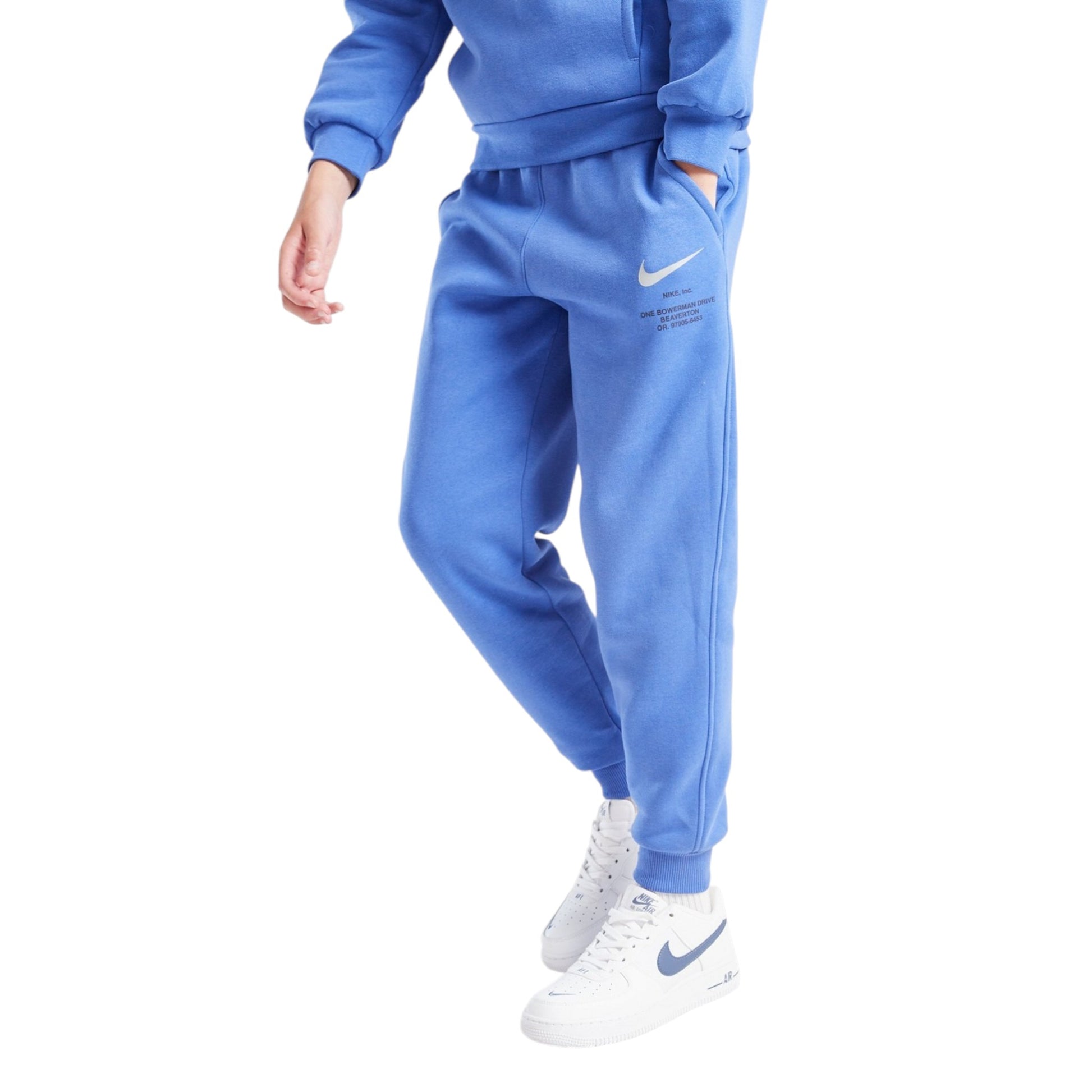 Blue Nike tracksuit with white Nike shoes on a white background