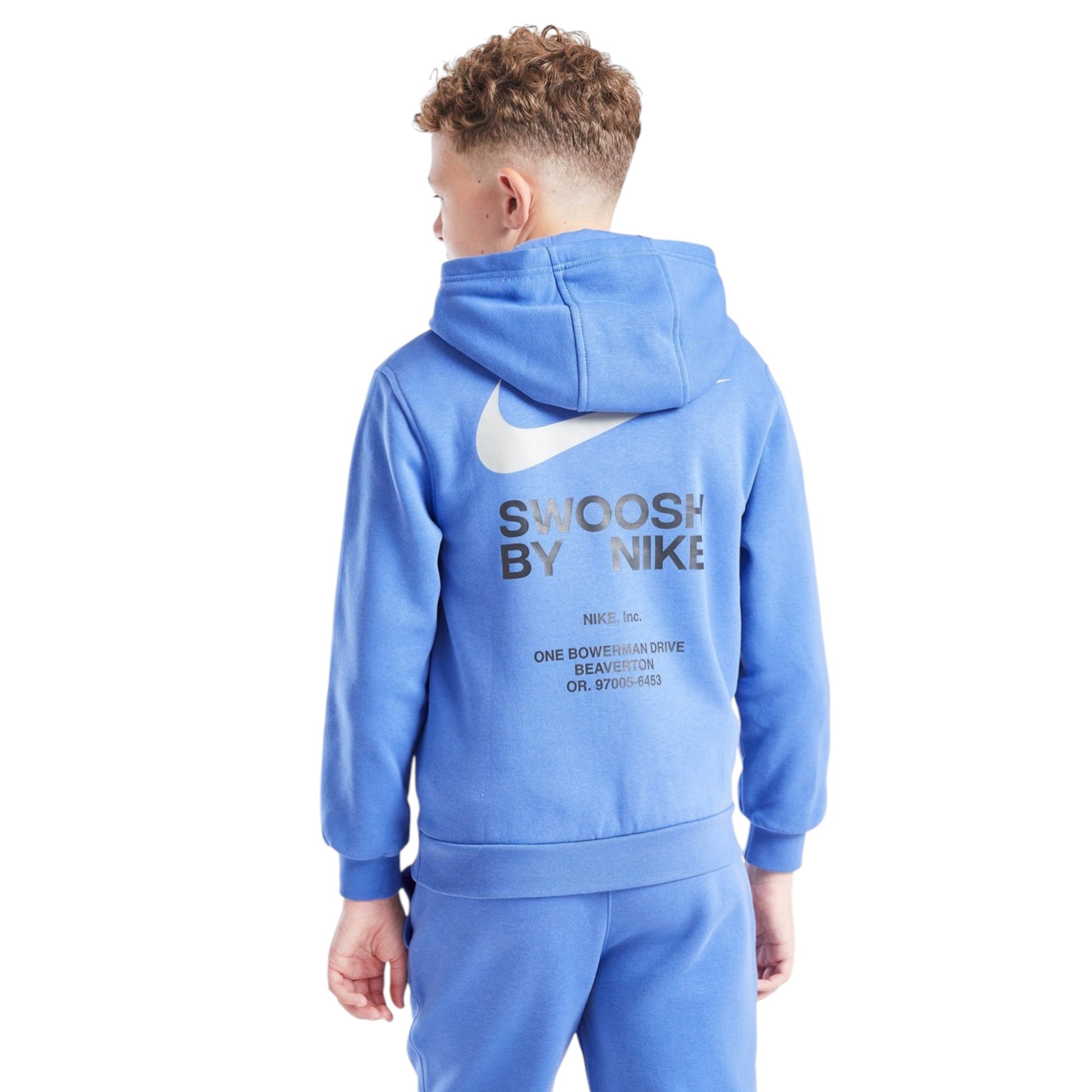 Child wearing a blue Nike hoodie with 'Swoosh by Nike' text on the back against a white background