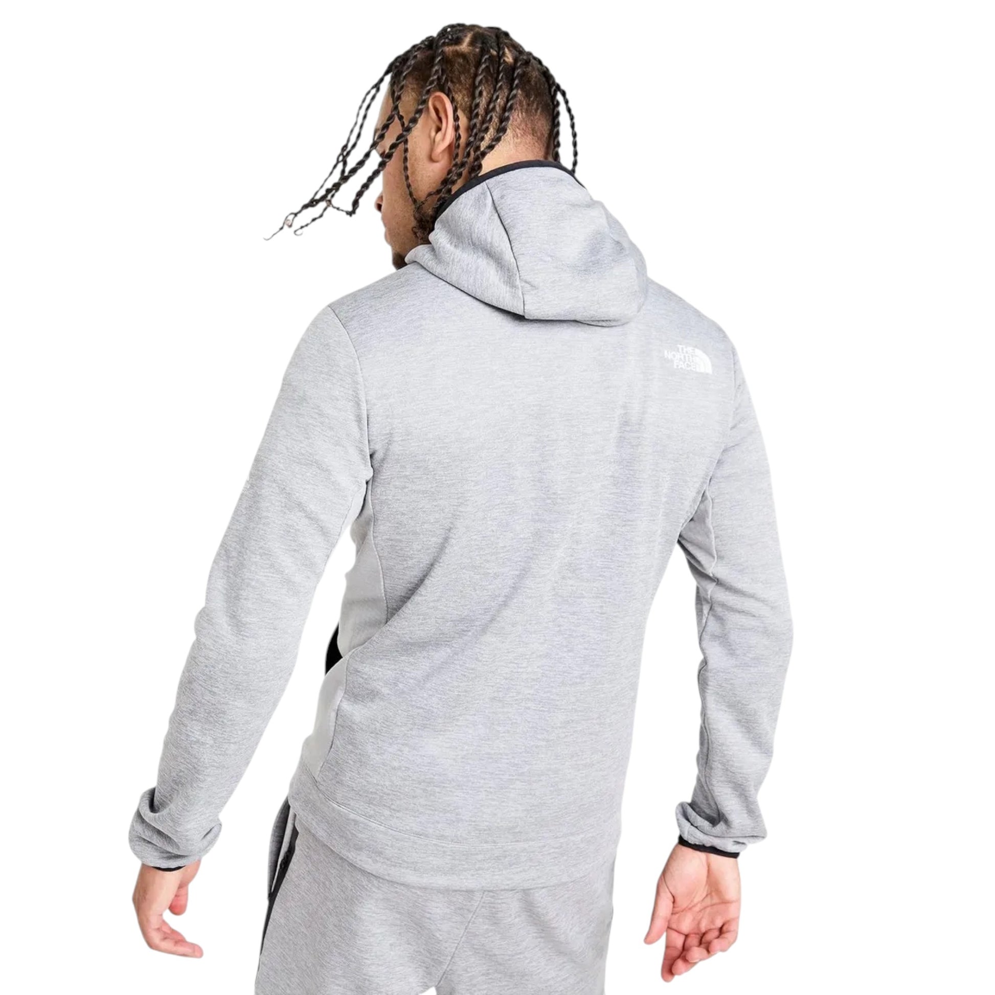 Person wearing a gray hoodie with a brand logo on a white background