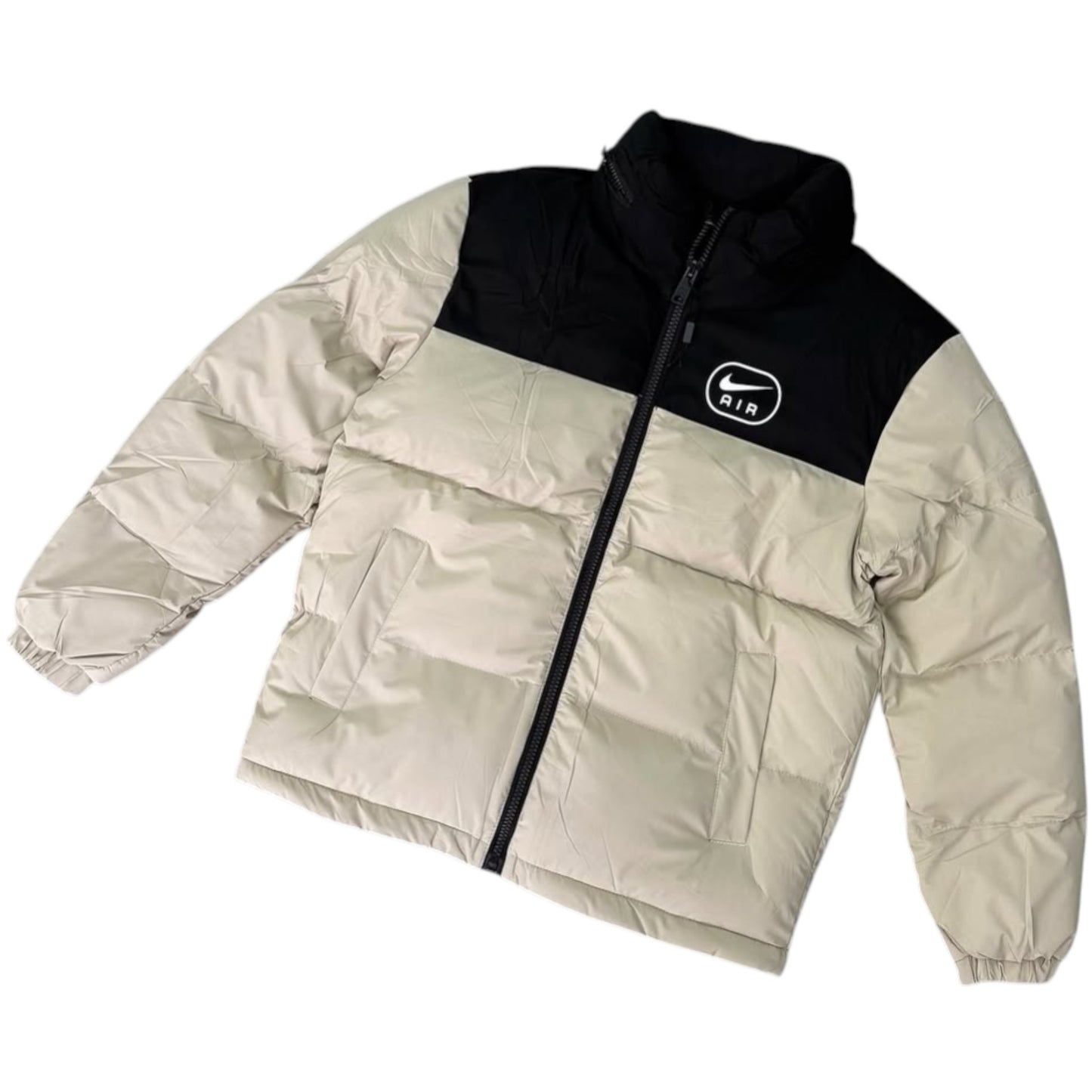 Two-tone puffer jacket with black and beige colors on a white background