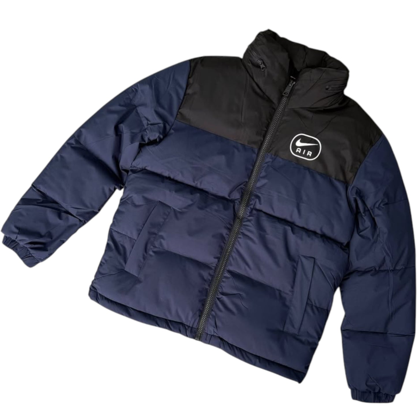 Navy and black puffer jacket with Nike logo on a white background