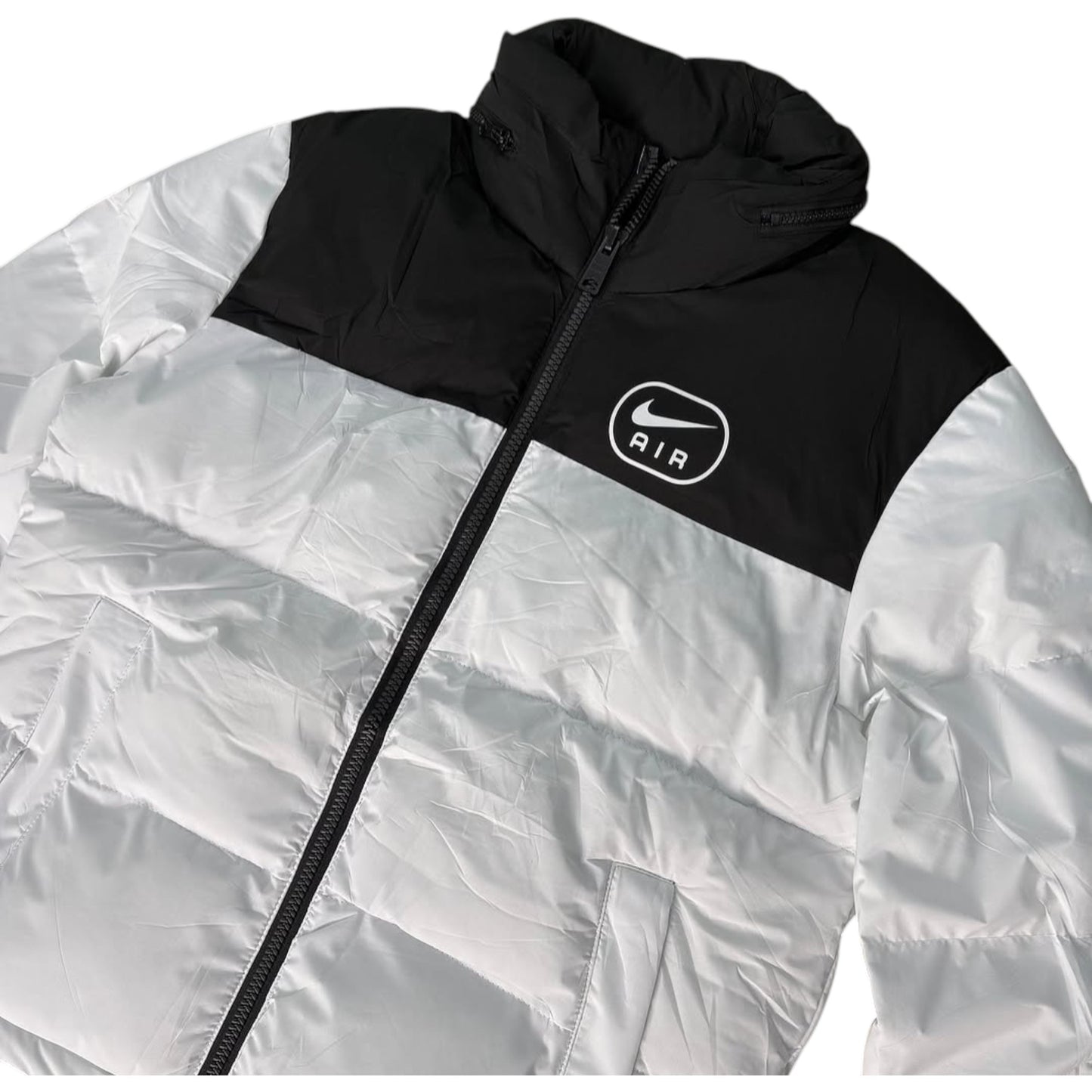 White and black jacket with Nike logo on a white background
