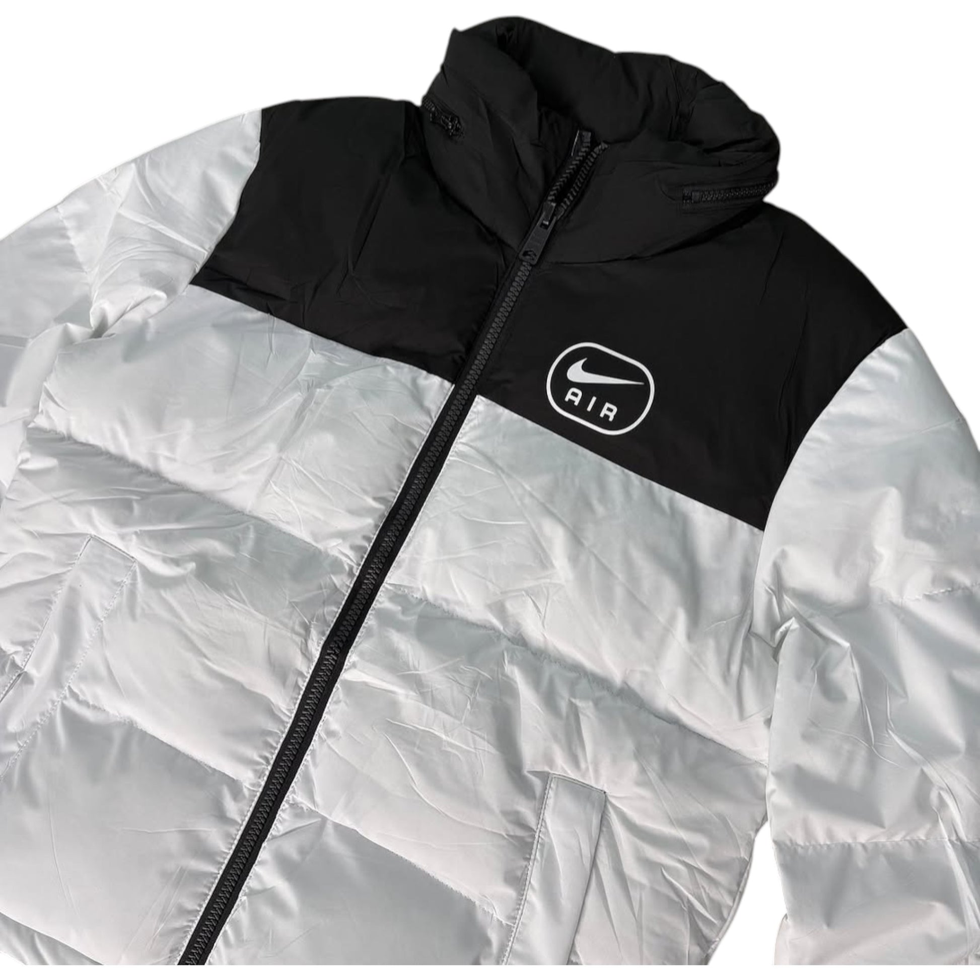 White and black jacket with Nike logo on a white background