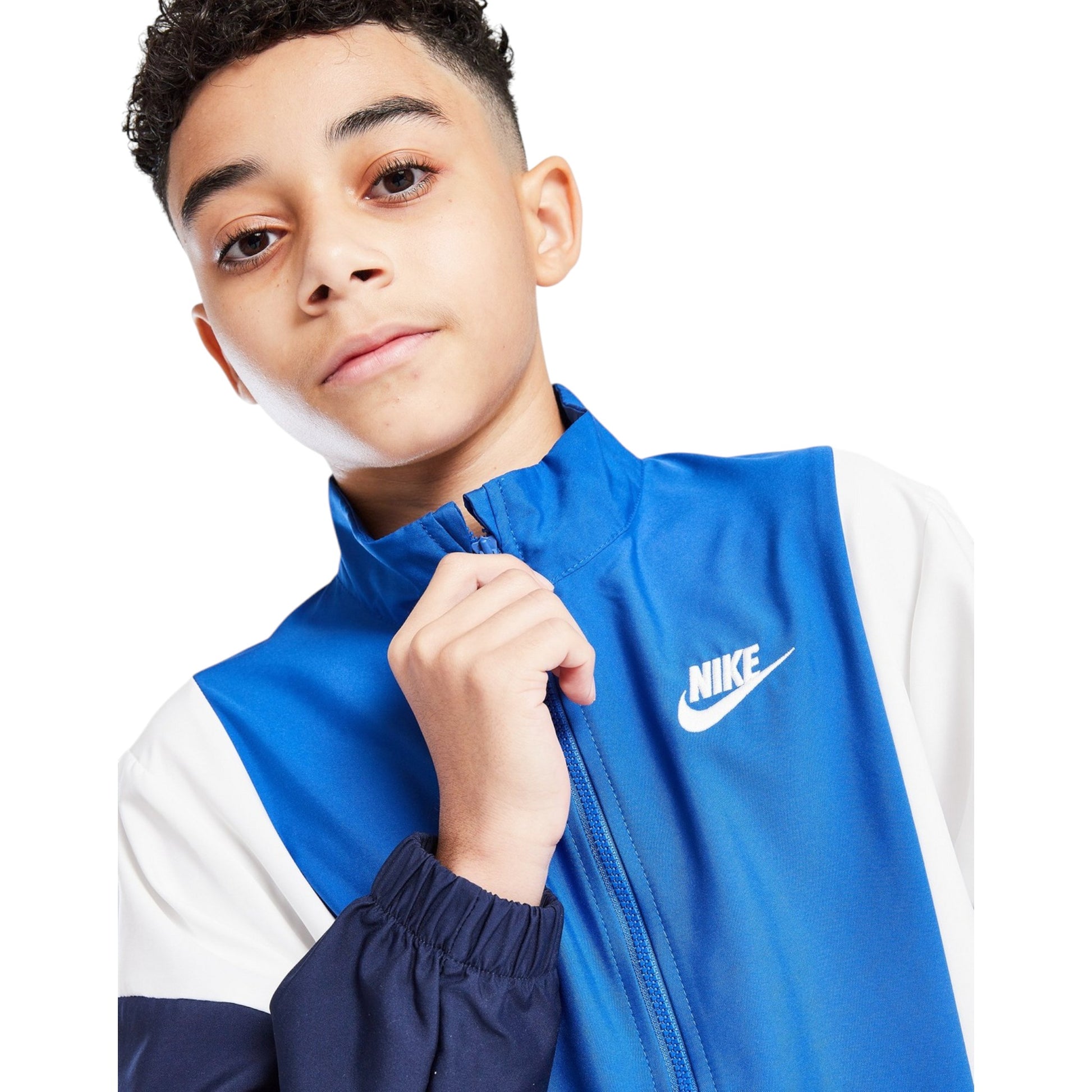 Child wearing a blue and white Nike jacket on a white background