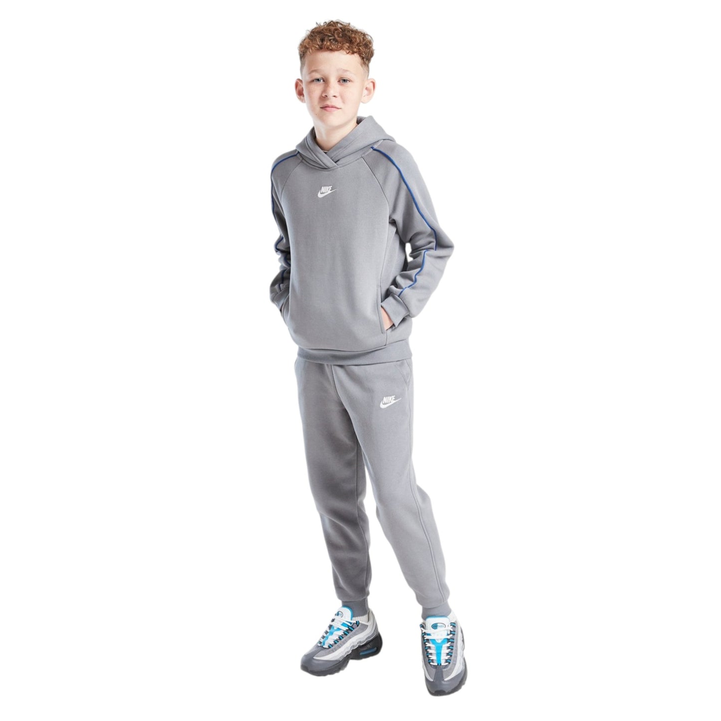 Child wearing a gray Nike tracksuit on a white background
