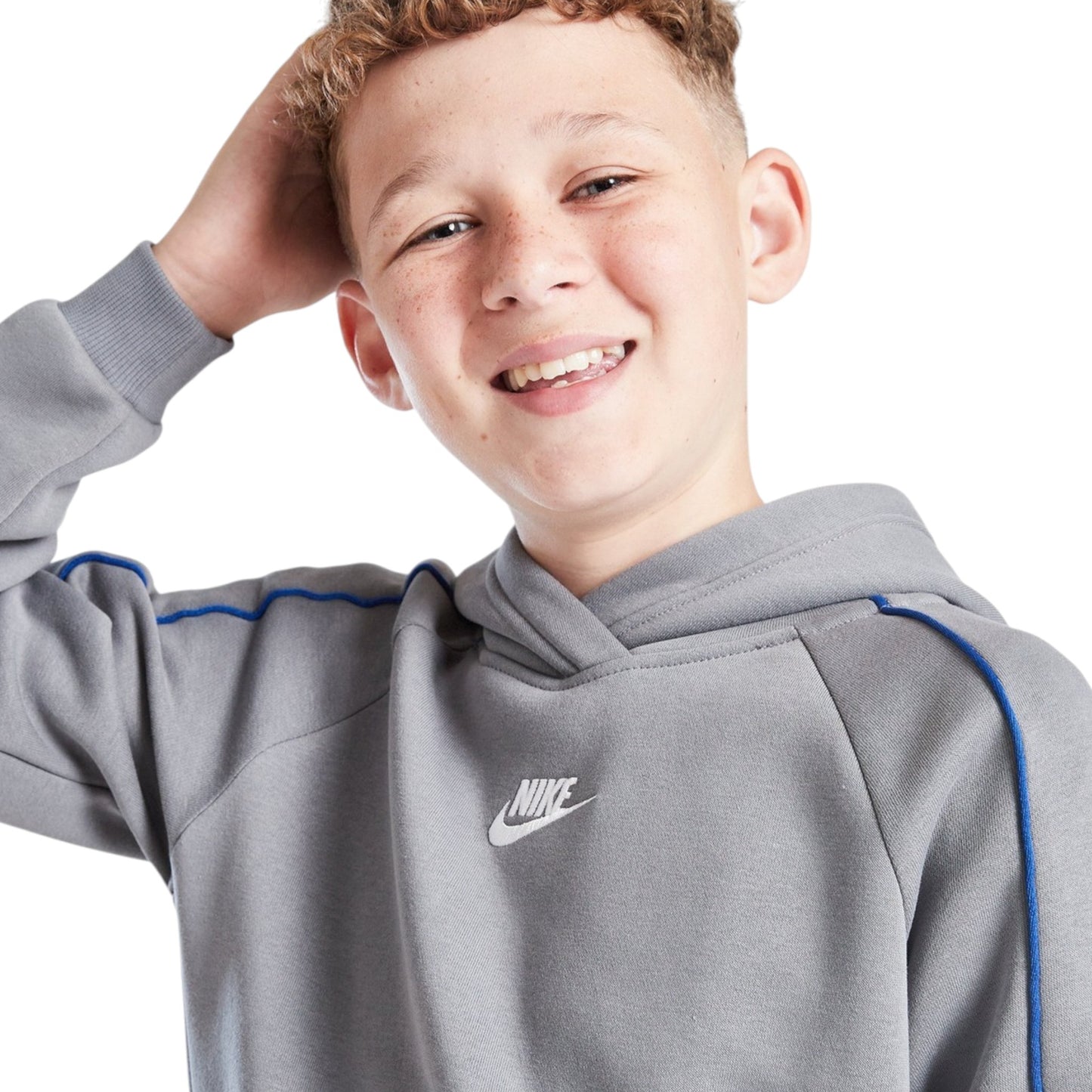 Child wearing a gray Nike hoodie on a white background