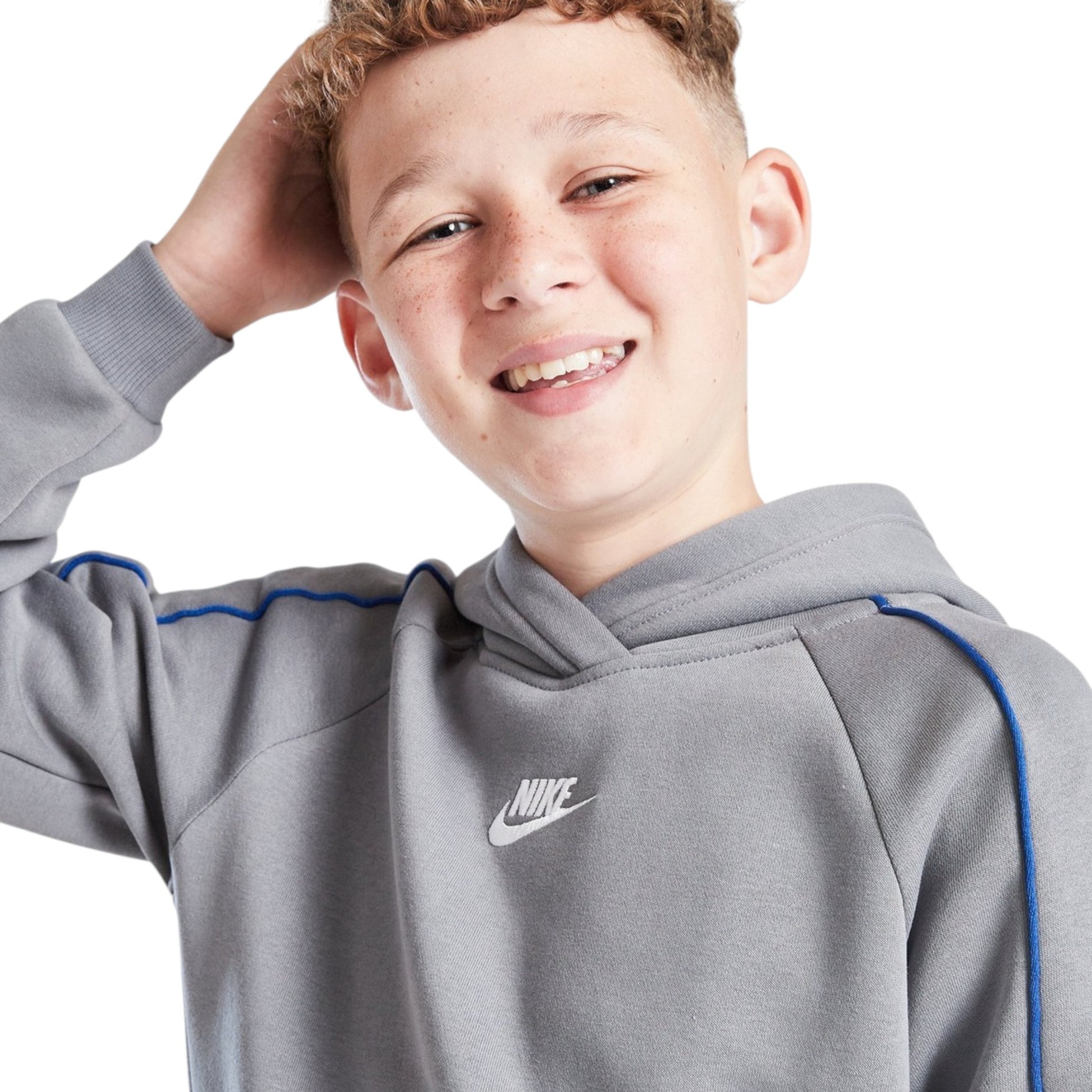 Child wearing a gray Nike hoodie on a white background