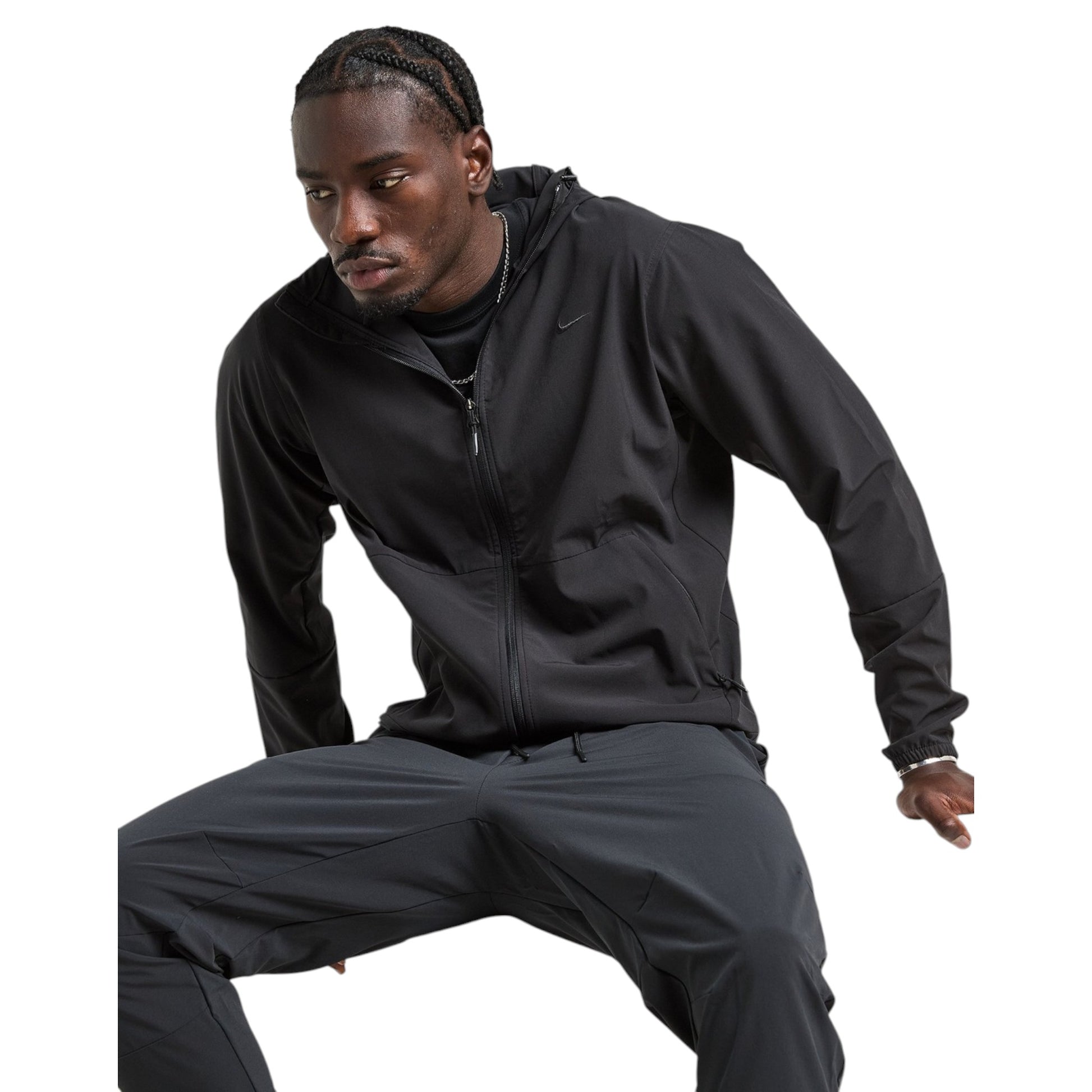 Man wearing a black Nike tracksuit on a white background