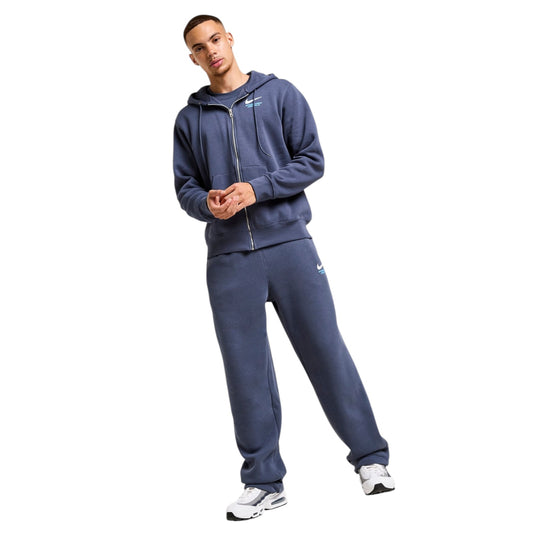 Man wearing a blue tracksuit on a white background