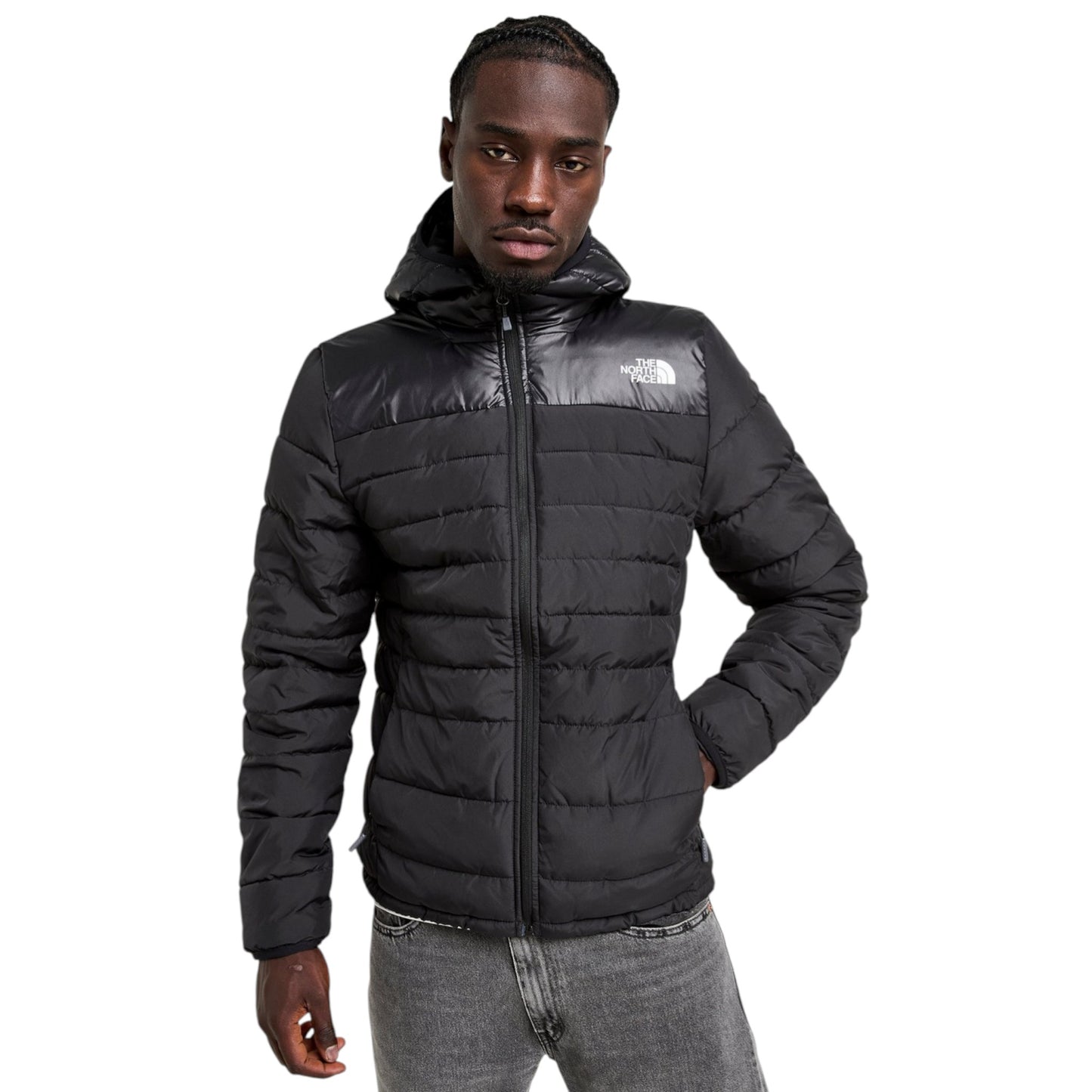 Person wearing a black puffer jacket with a brand logo on a white background