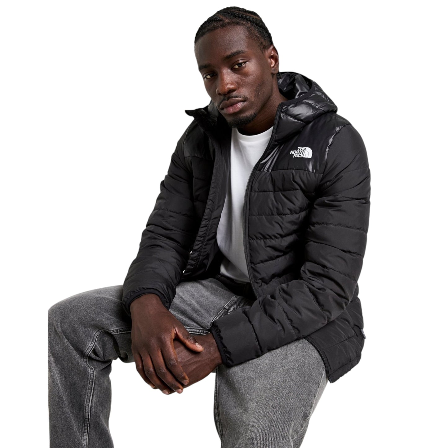 Man wearing a black puffer jacket with a brand logo on a white background