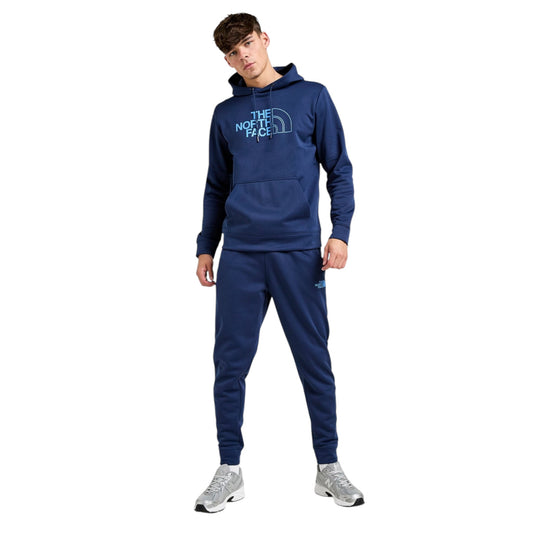 Person wearing a blue The North Face hoodie and pants on a white background
