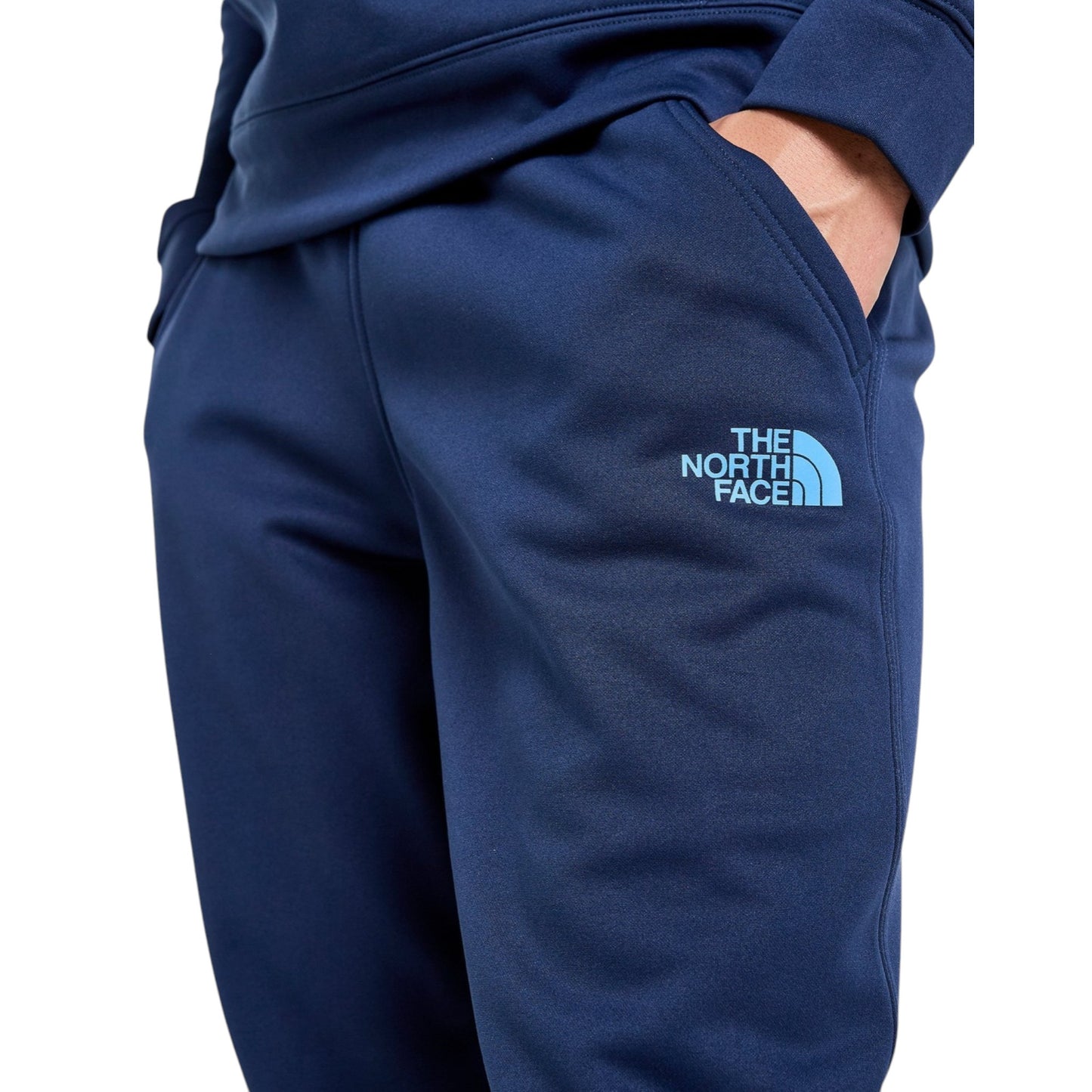 Blue sweatpants with The North Face logo on a white background