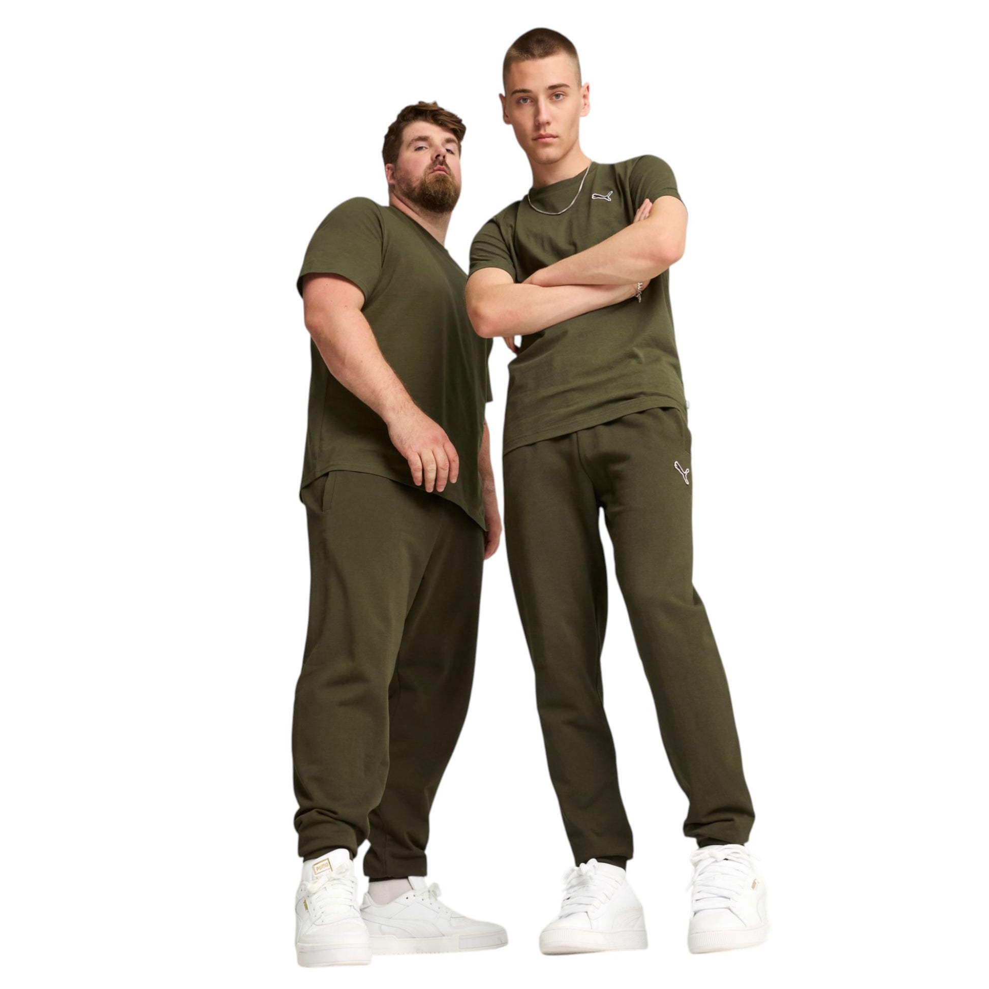 Two men wearing matching green outfits with white shoes on a white background