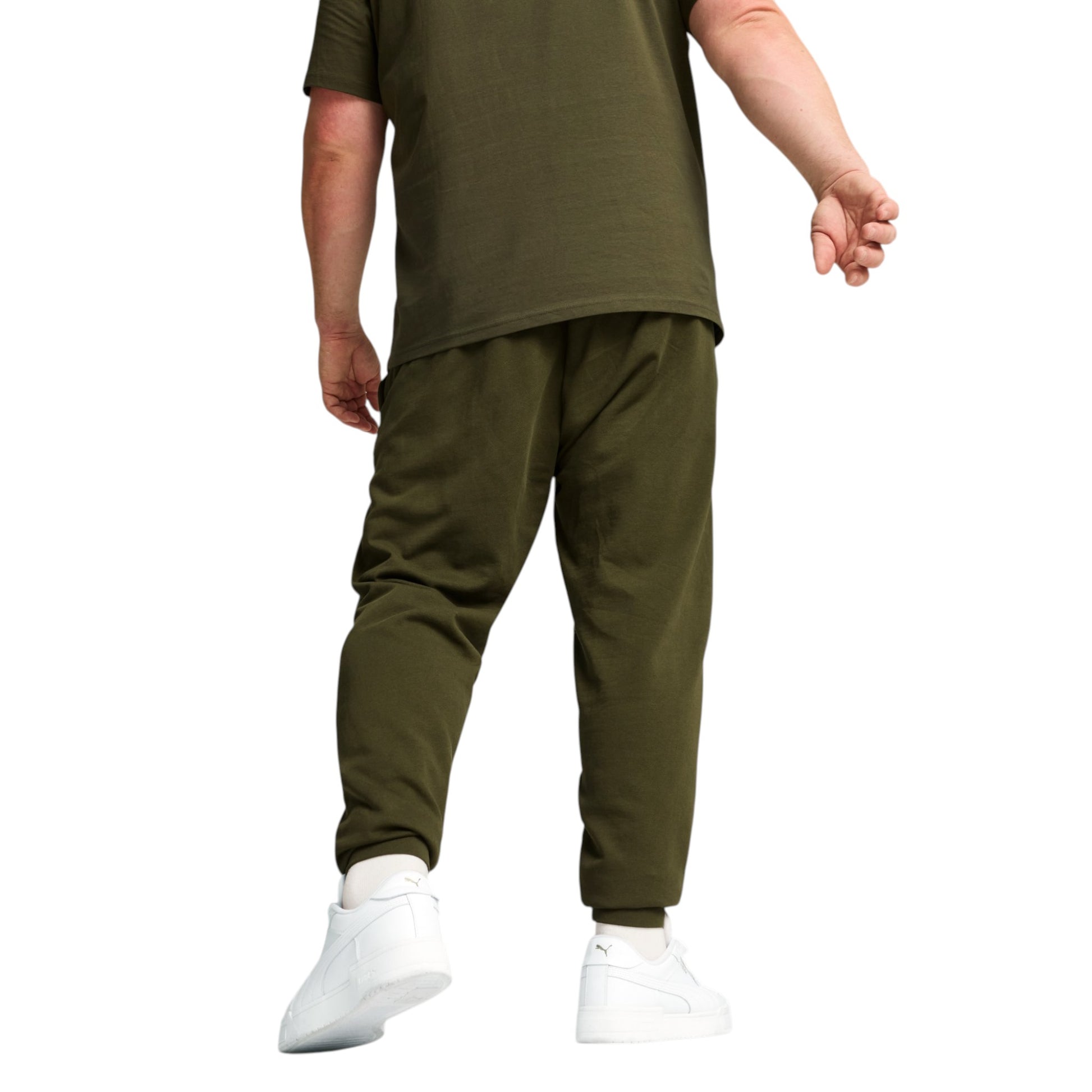 Person wearing an olive green outfit with white sneakers on a white background