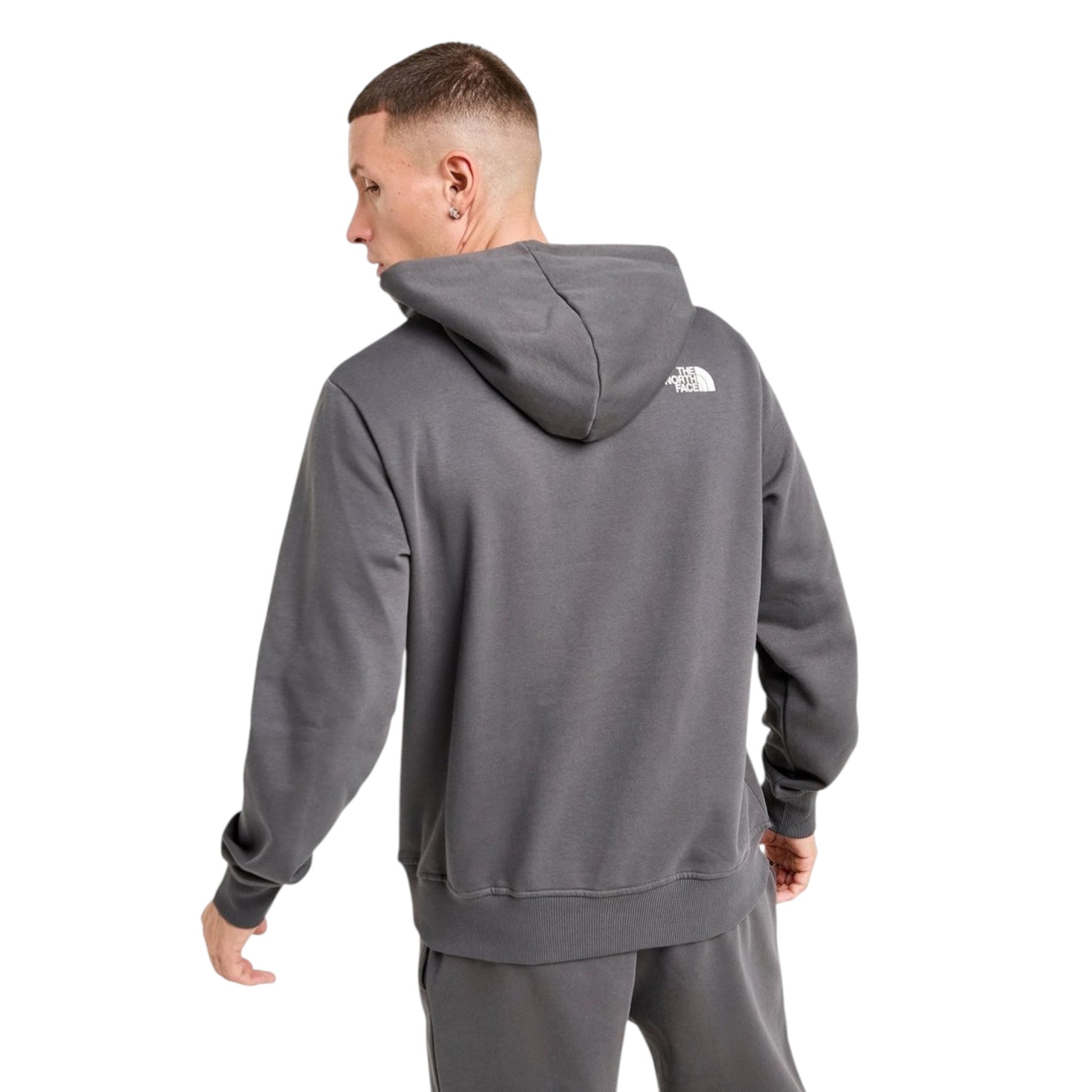Man wearing a gray hoodie with a brand logo on the back, on a white background
