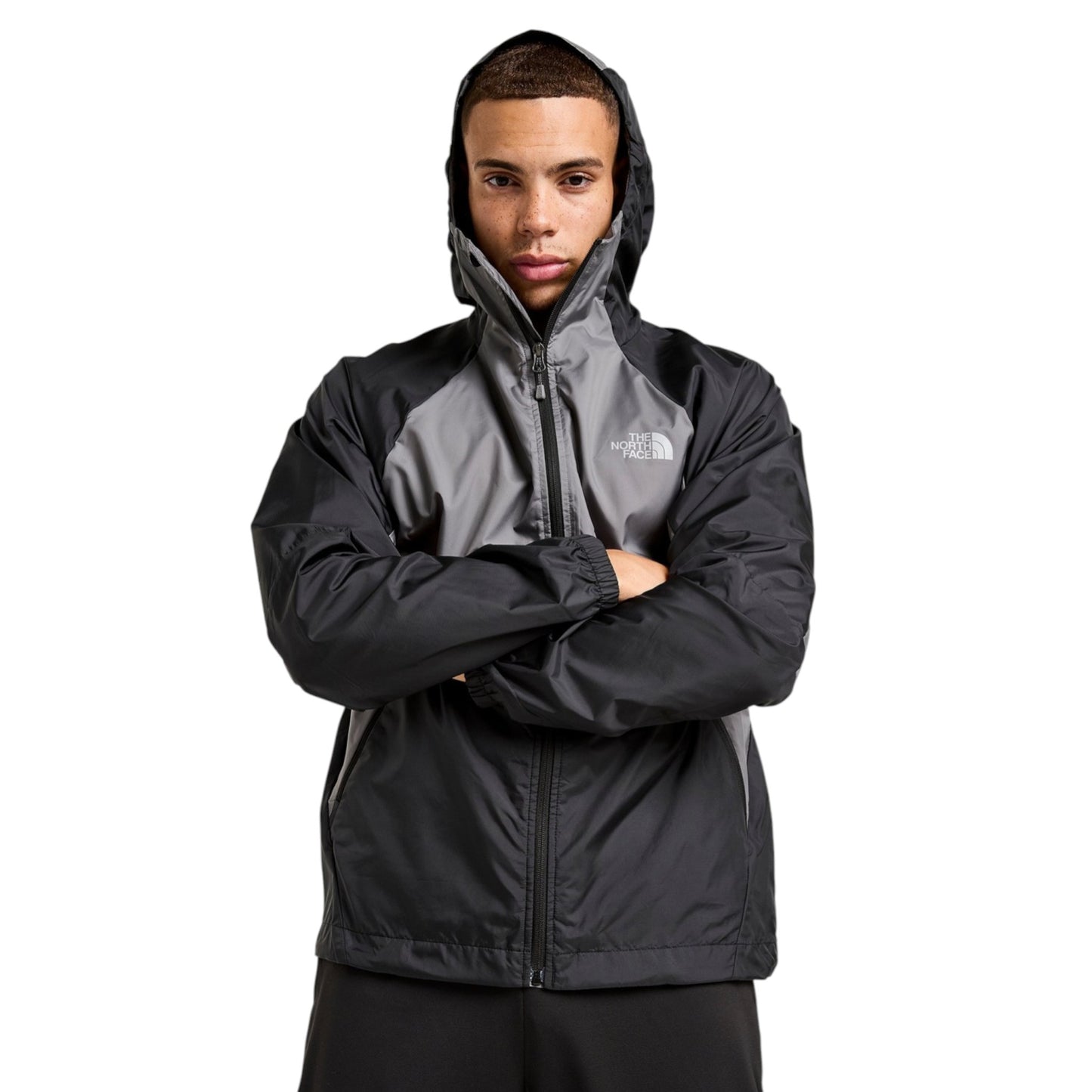 Person wearing a black and gray jacket with The North Face logo on a white background