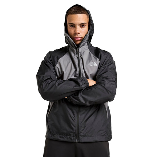 Person wearing a black and gray jacket with The North Face logo on a white background