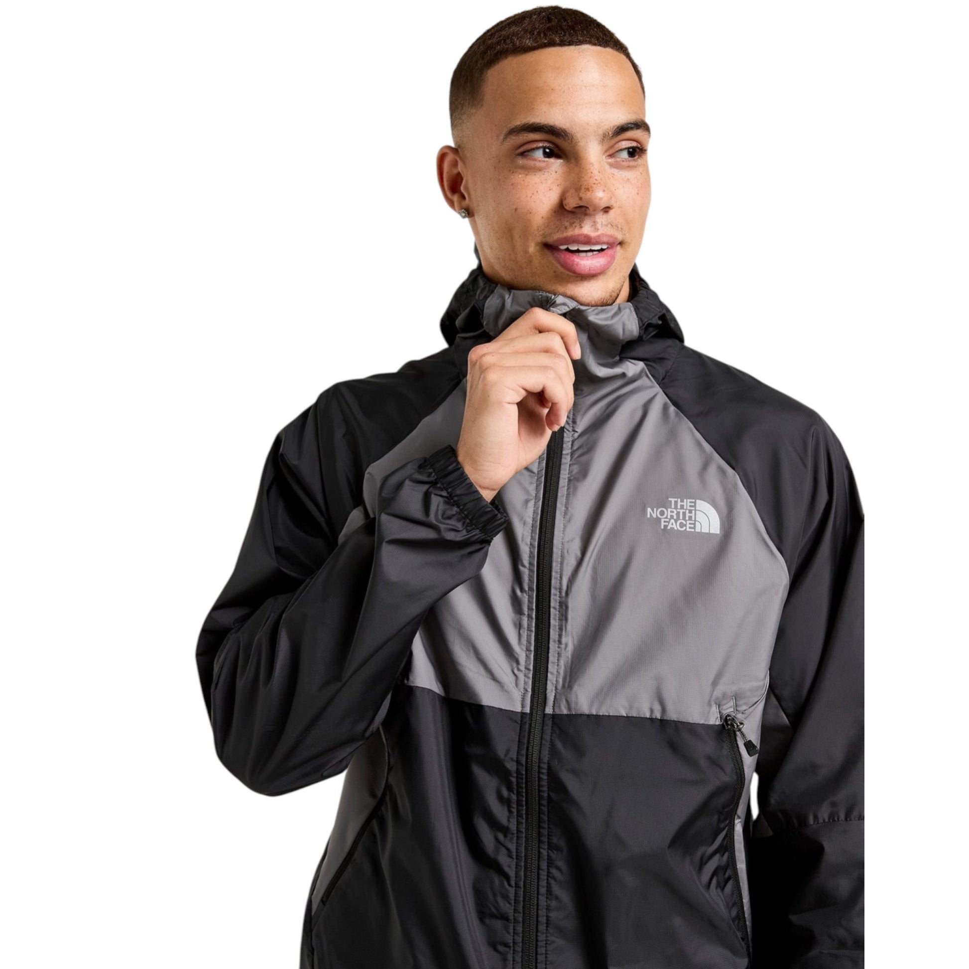 Man wearing a black and gray jacket with The North Face logo on a white background