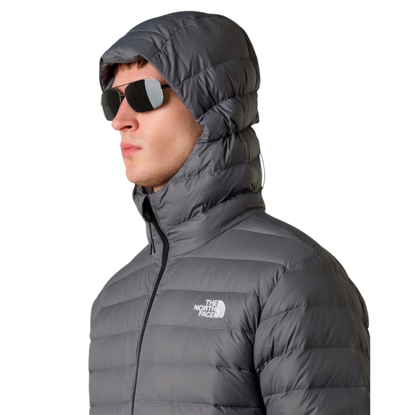 Person wearing a gray The North Face jacket on a white background