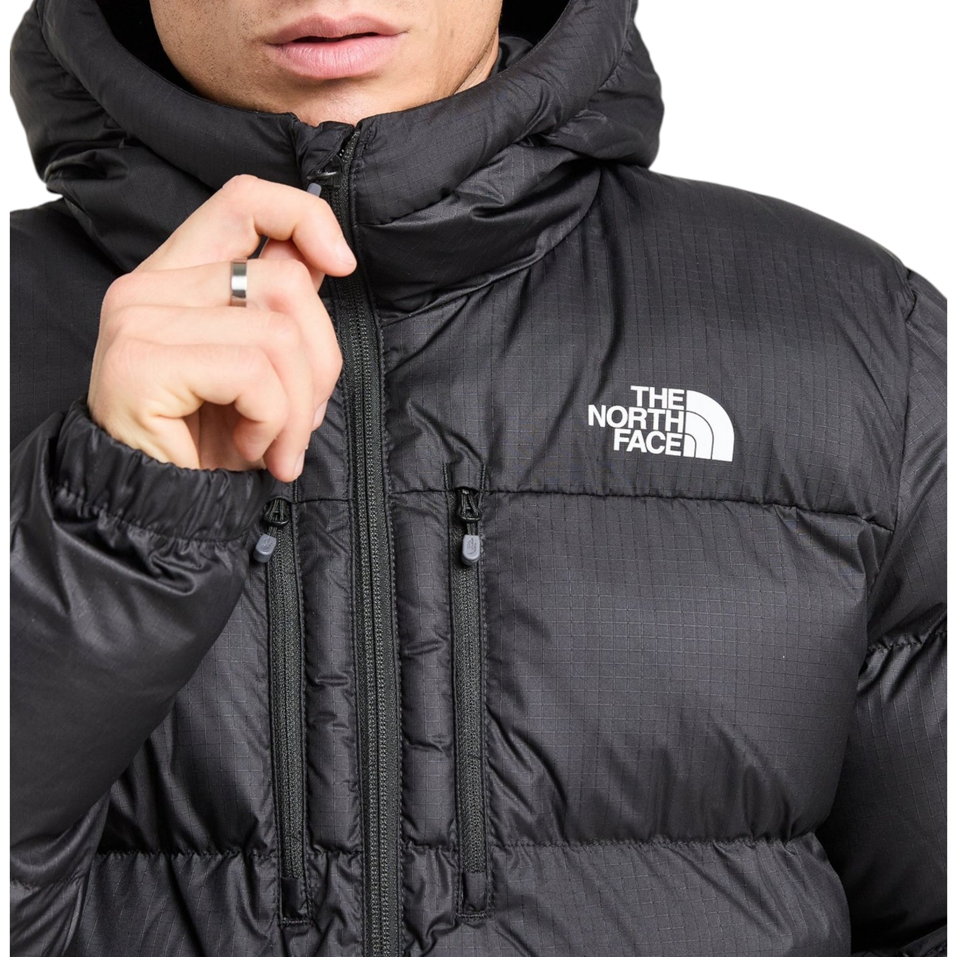 Black puffer jacket with The North Face logo on a white background