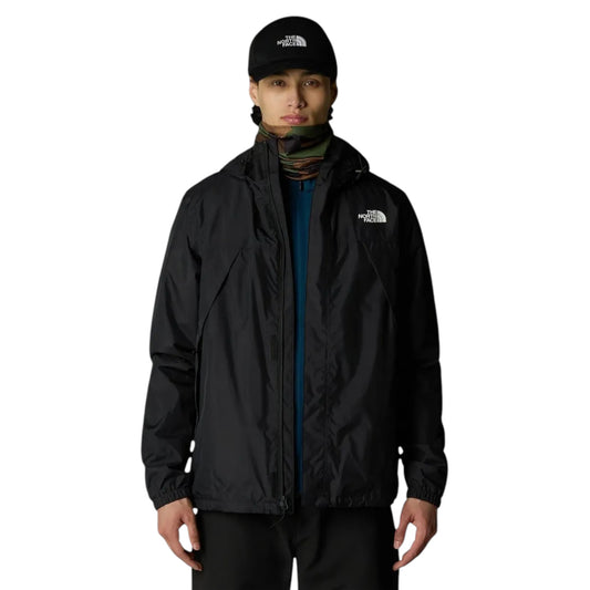 Person wearing a black jacket and cap with 'The North Face' logo on a white background